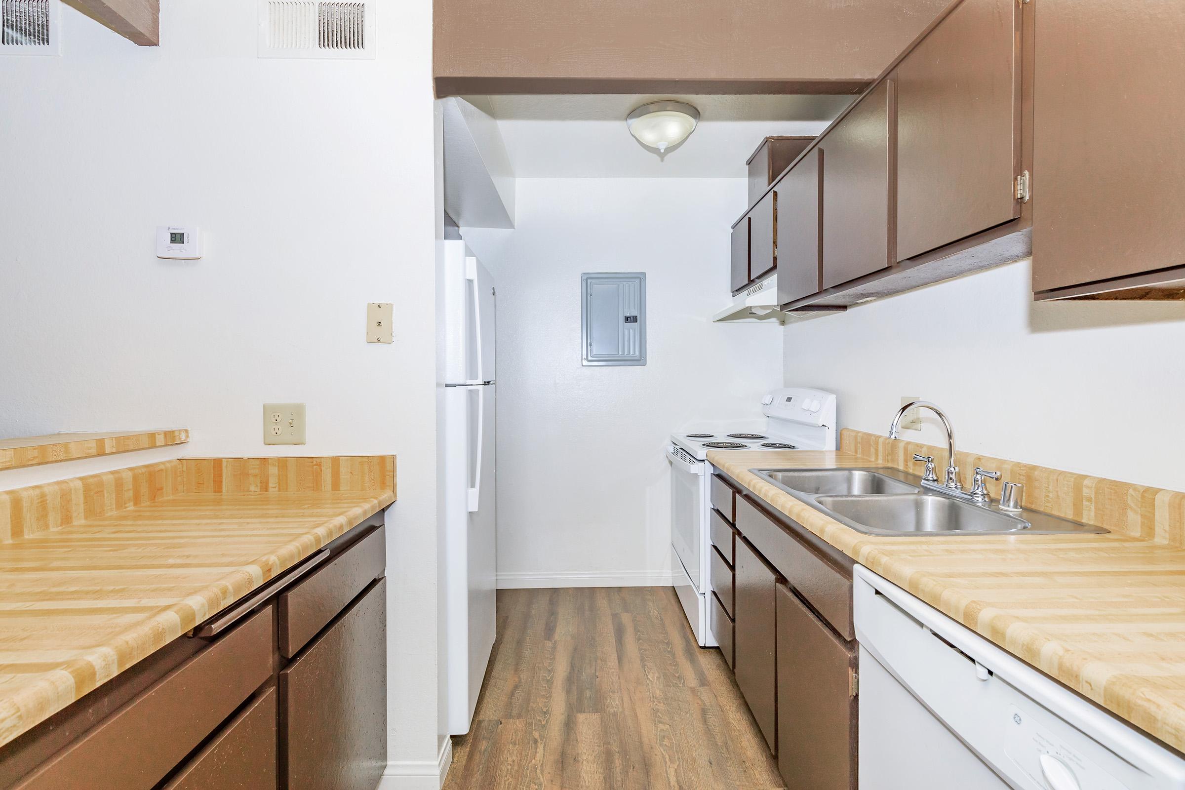 a kitchen with a sink and a mirror