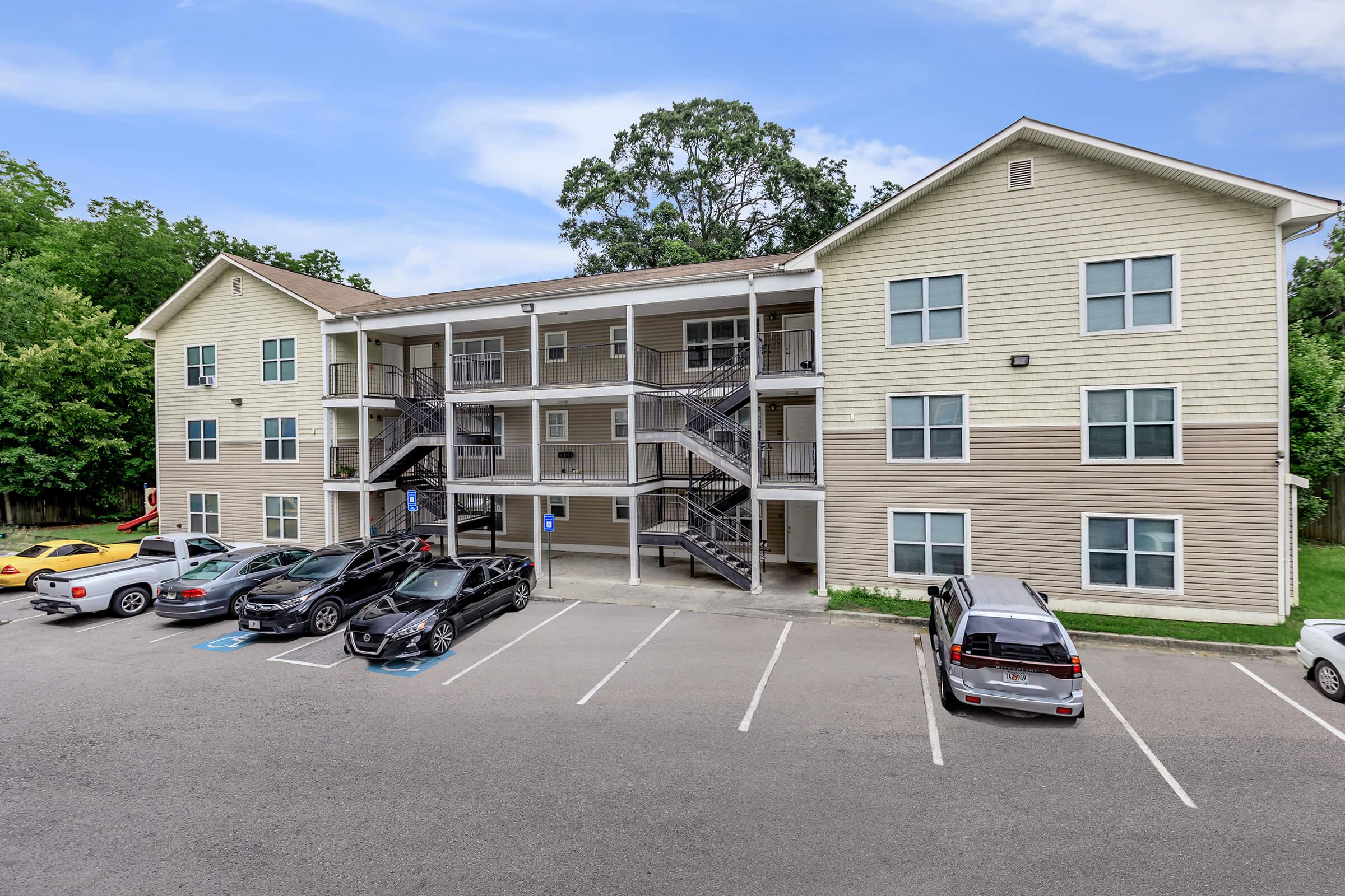 a car parked in a parking lot in front of a house