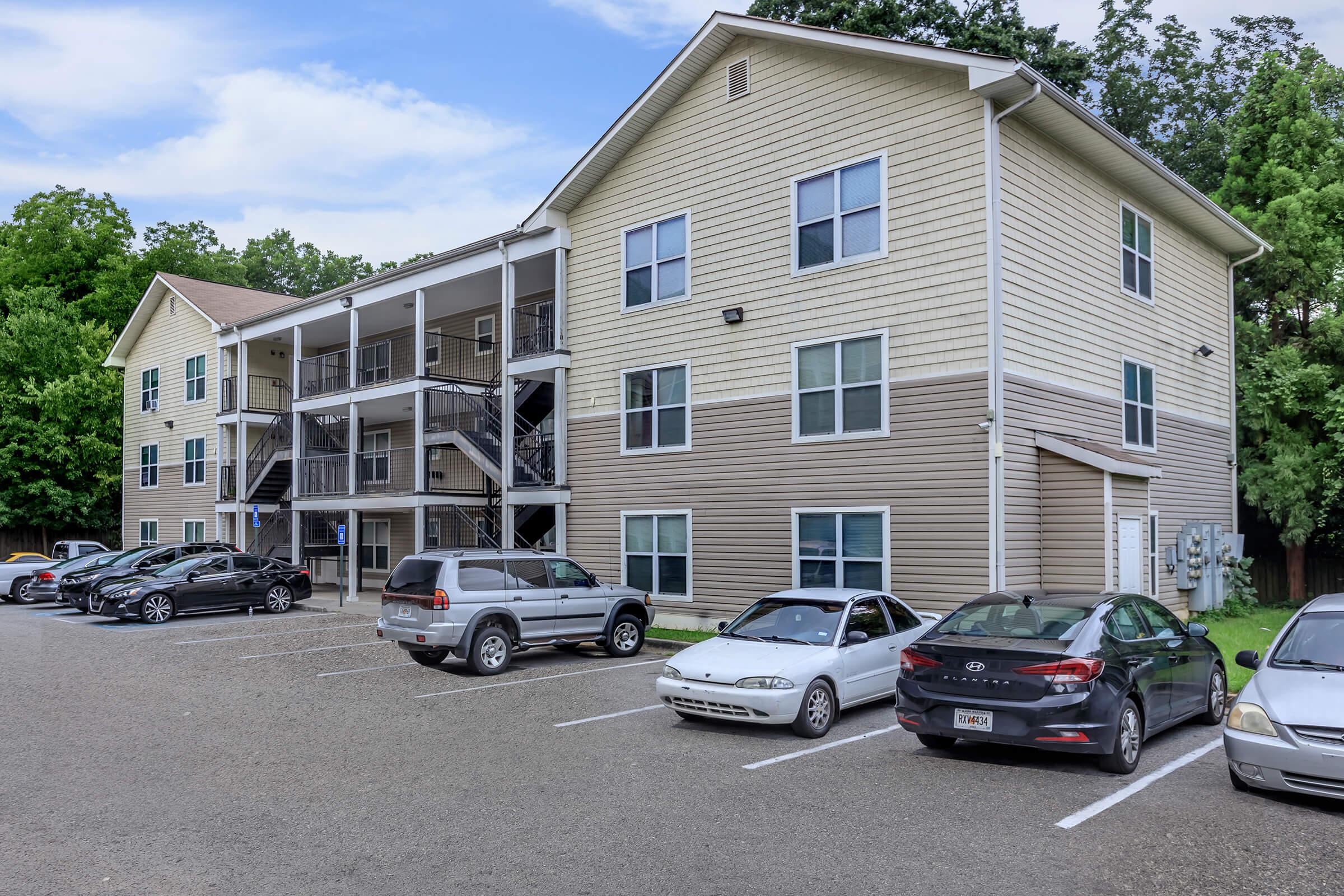 a car parked in a parking lot in front of a house