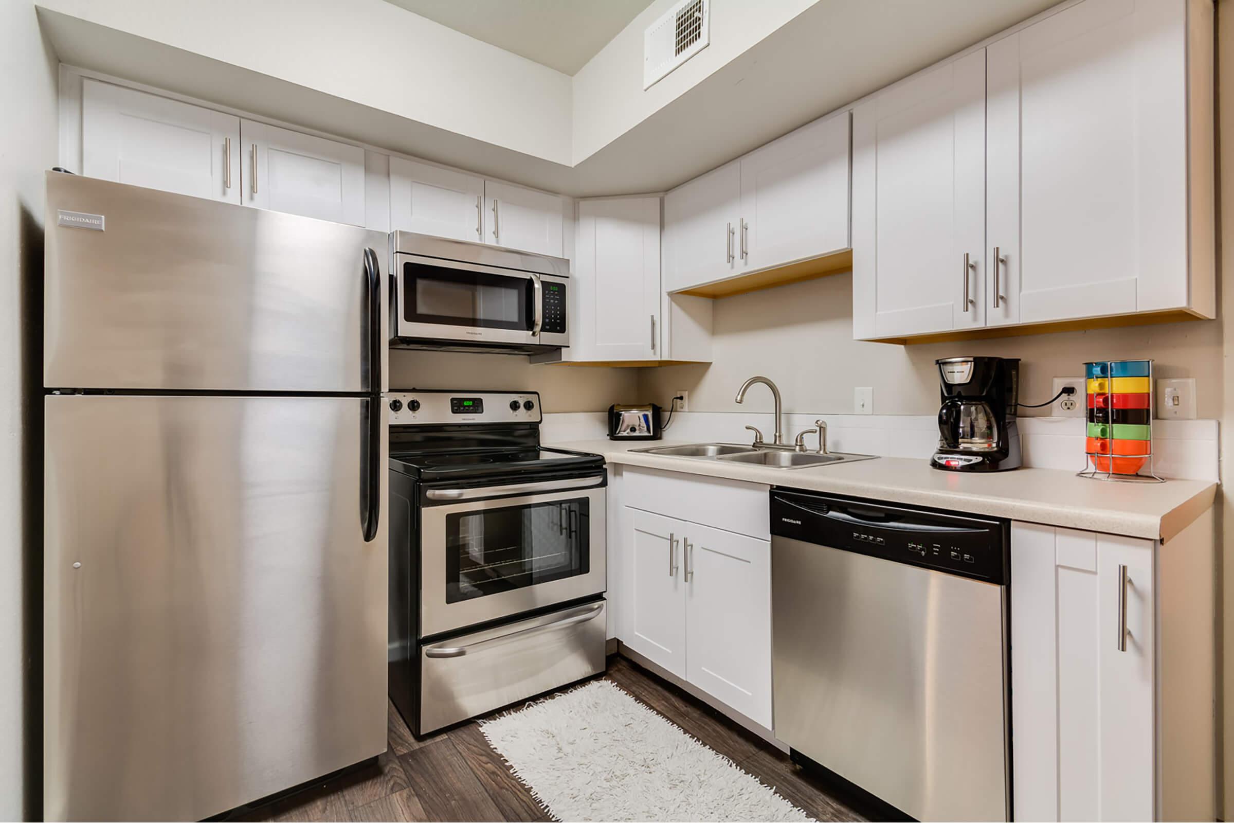 a kitchen with stainless steel appliances and wooden cabinets