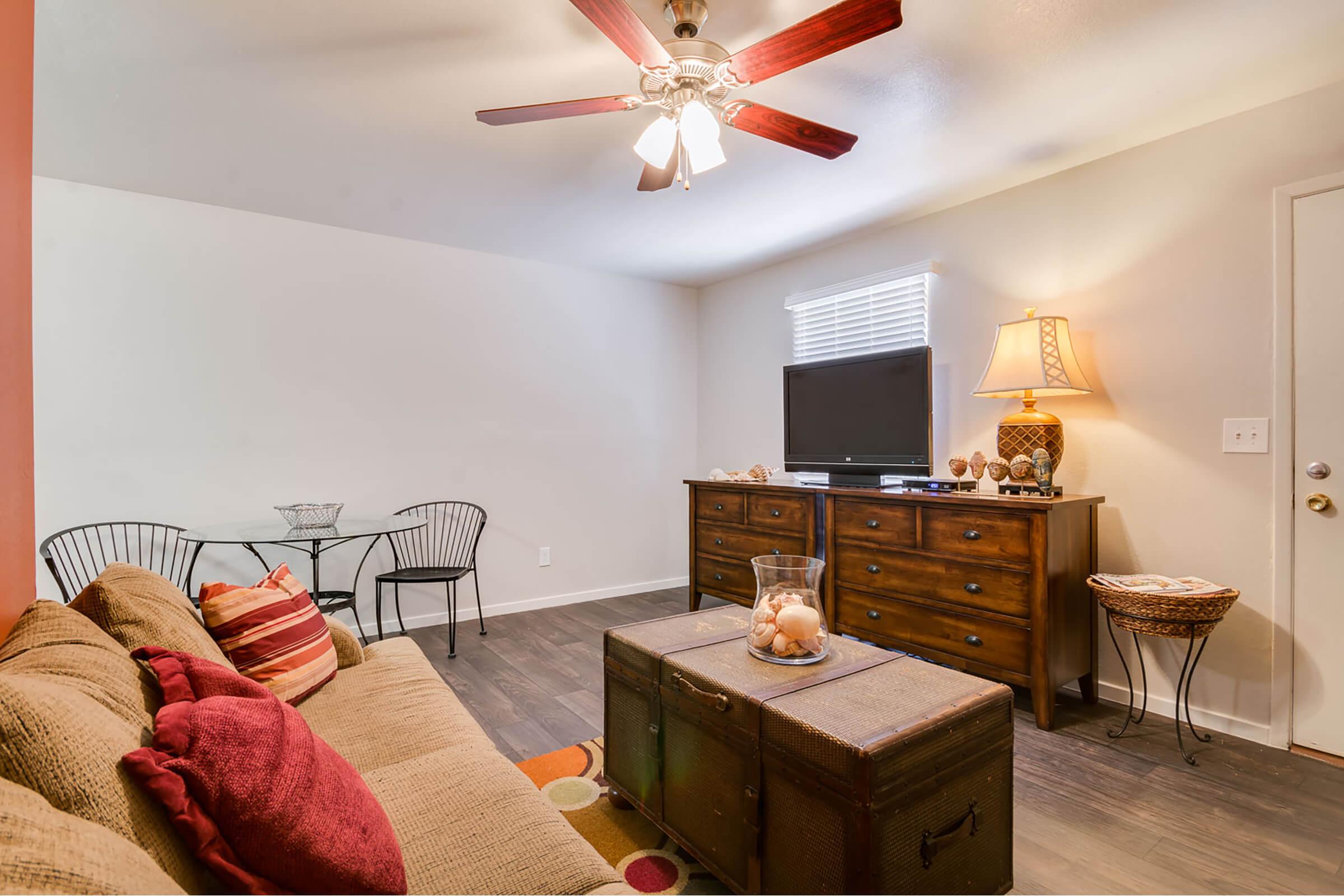 a bedroom with a bed and a table in a room