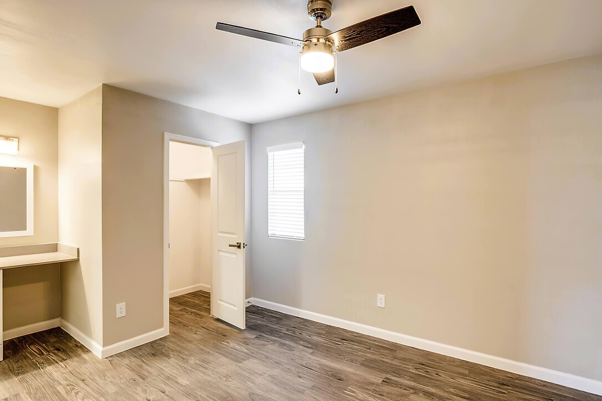 a large empty room with a sink and a mirror