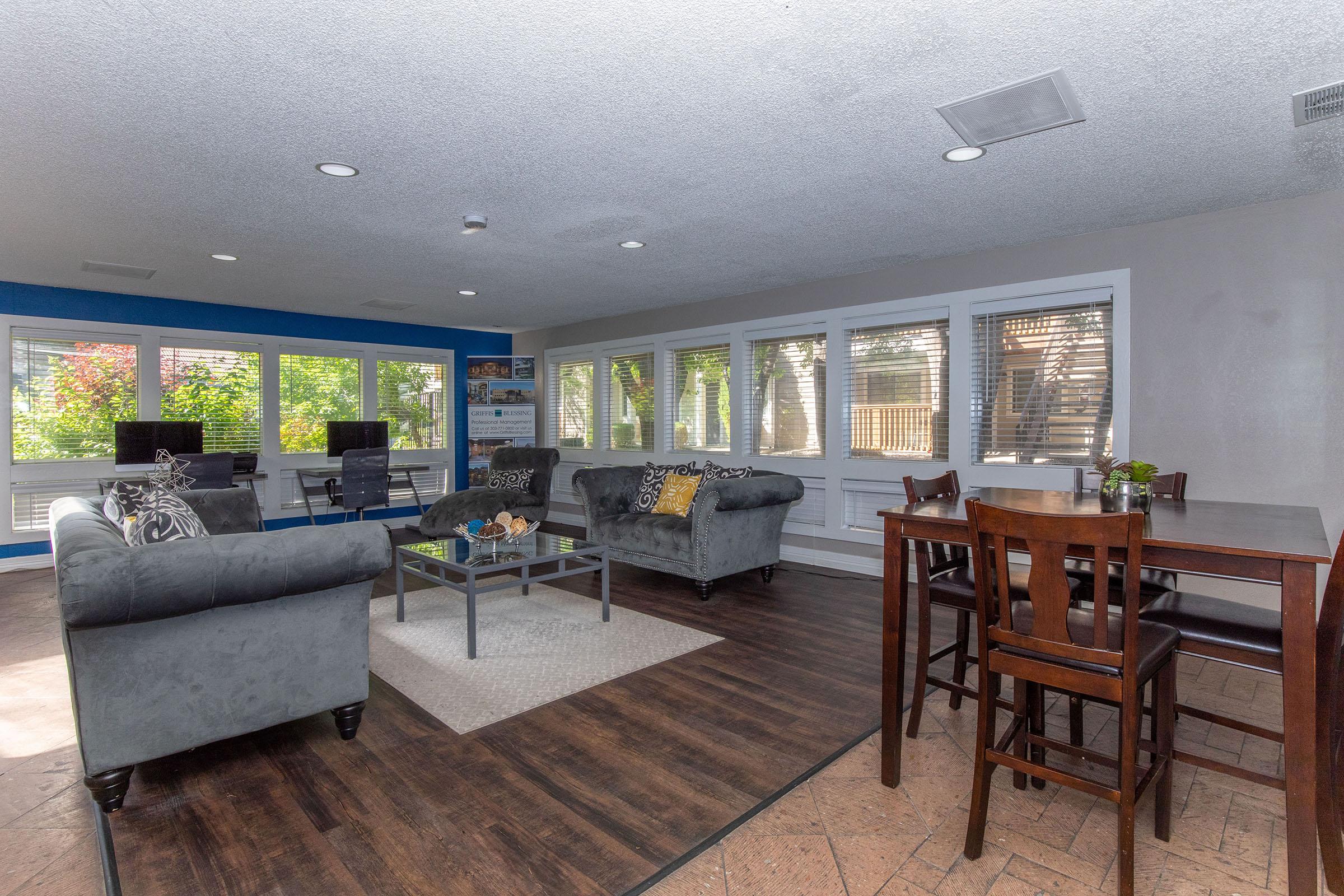 a living room filled with furniture and a large window