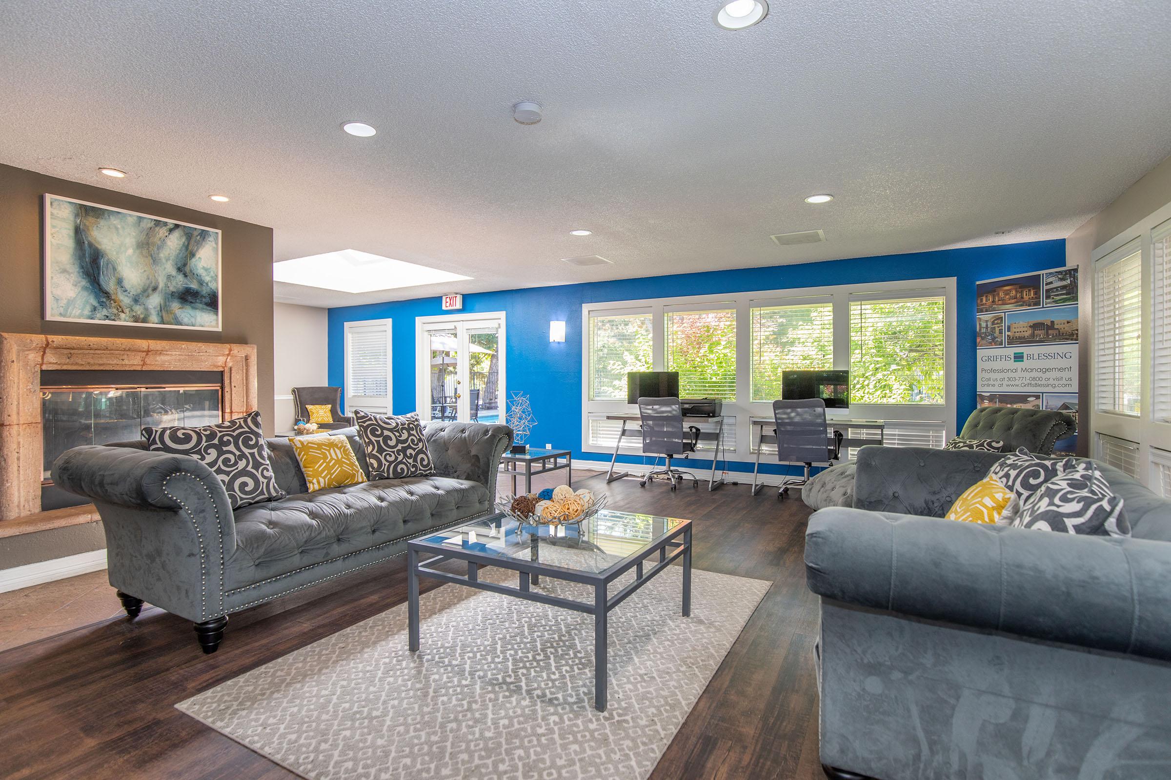 a living room filled with furniture and a large window