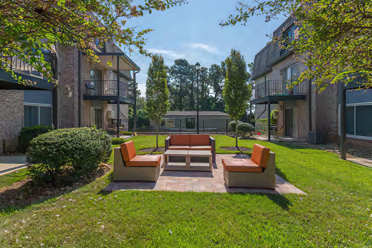 a couple of lawn chairs sitting on a bench in front of a house