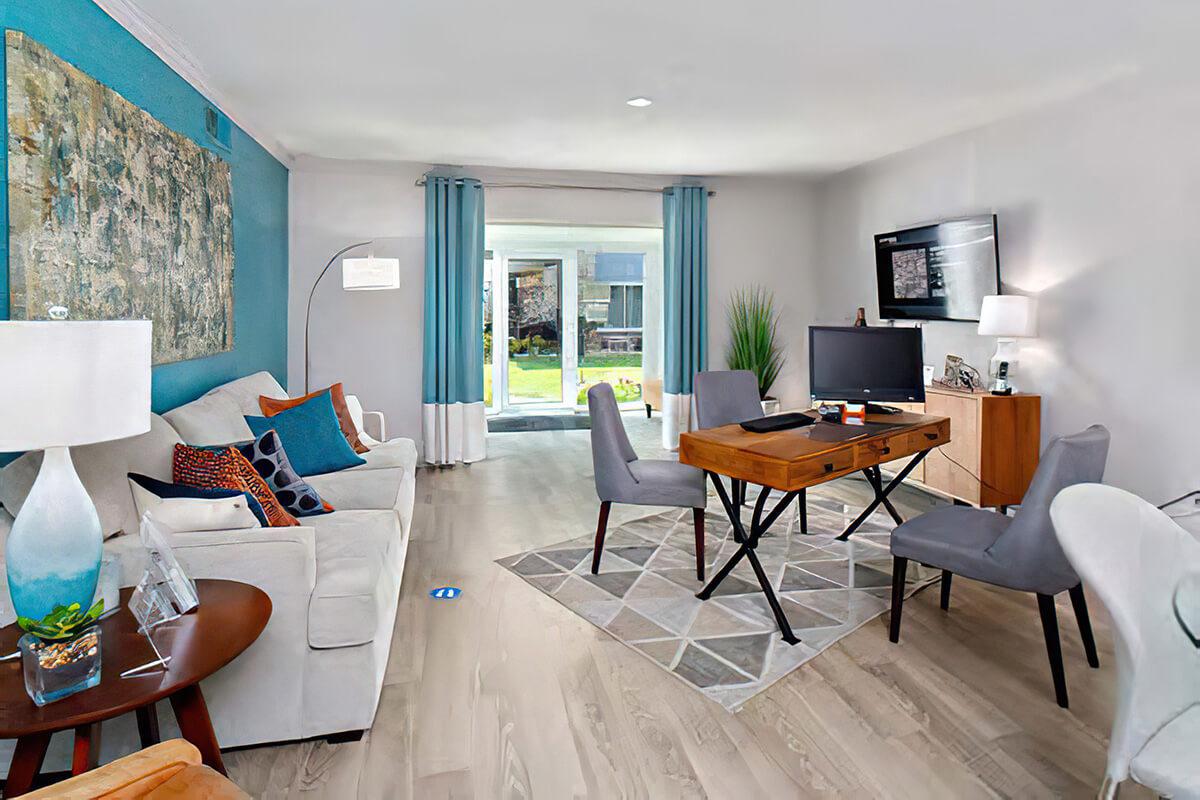 a living room filled with furniture and a large window