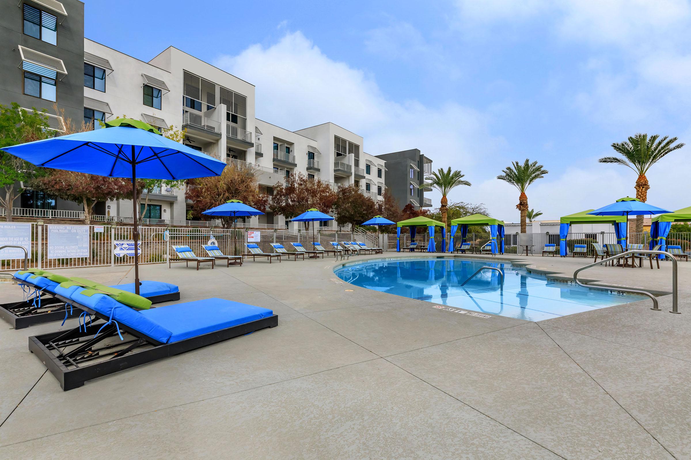 a blue umbrella sitting next to a pool