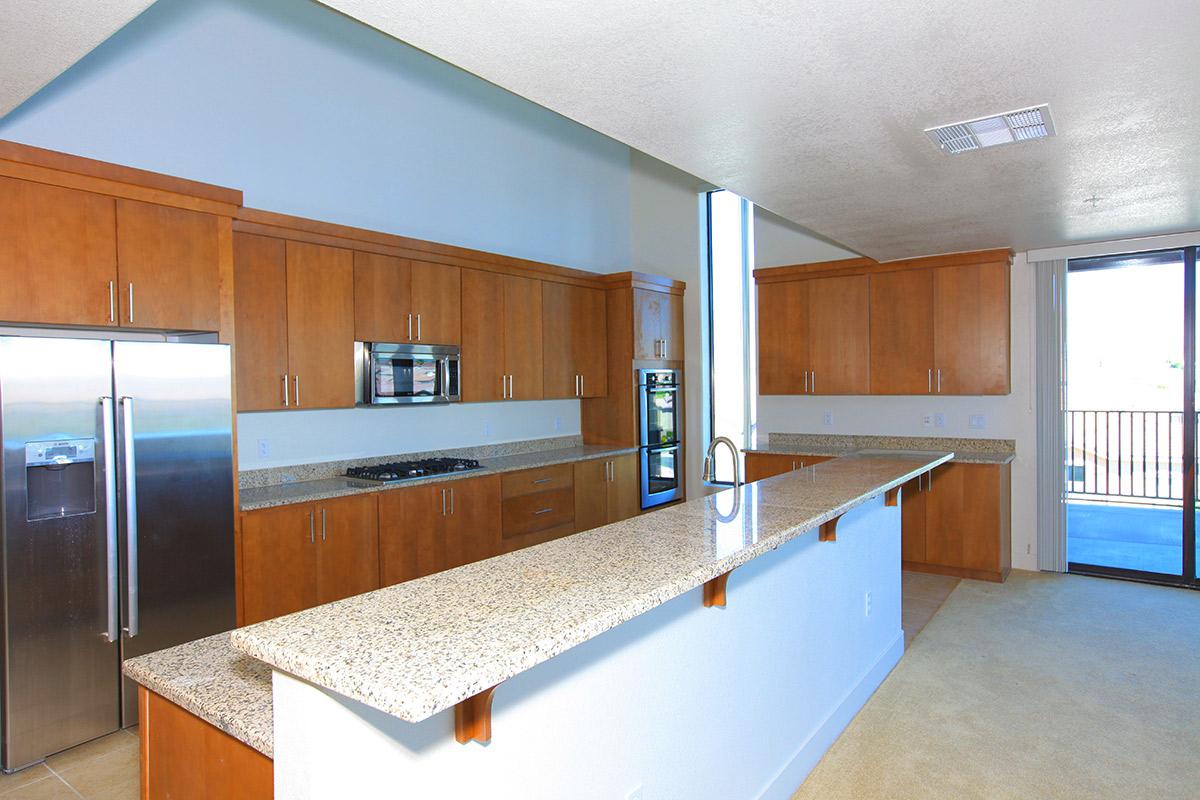 a modern kitchen with stainless steel appliances and wooden cabinets