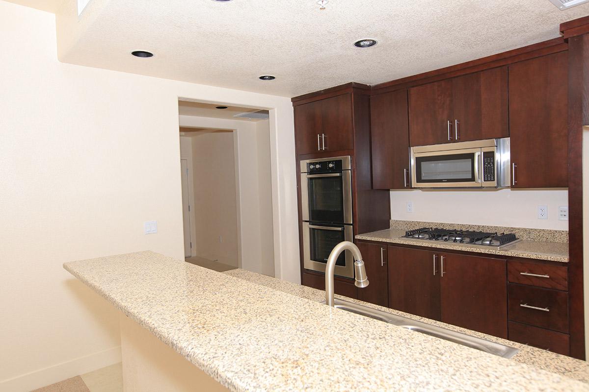 a kitchen with stainless steel appliances and wooden cabinets
