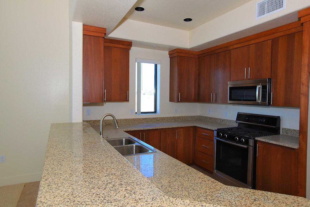 a kitchen with stainless steel appliances and wooden cabinets