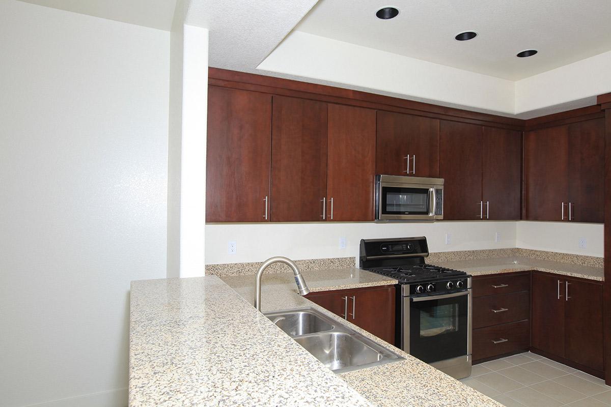 a kitchen with stainless steel appliances and wooden cabinets