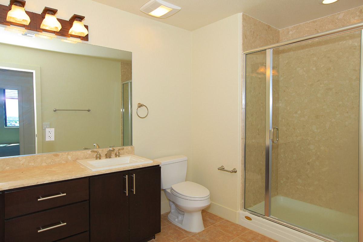 a white sink sitting next to a shower
