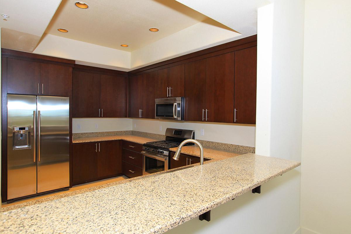 BREAKFAST BAR AND STAINLESS STEEL APPLIANCES AT ECHELON AT CENTENNIAL HILLS IN LAS VEGAS