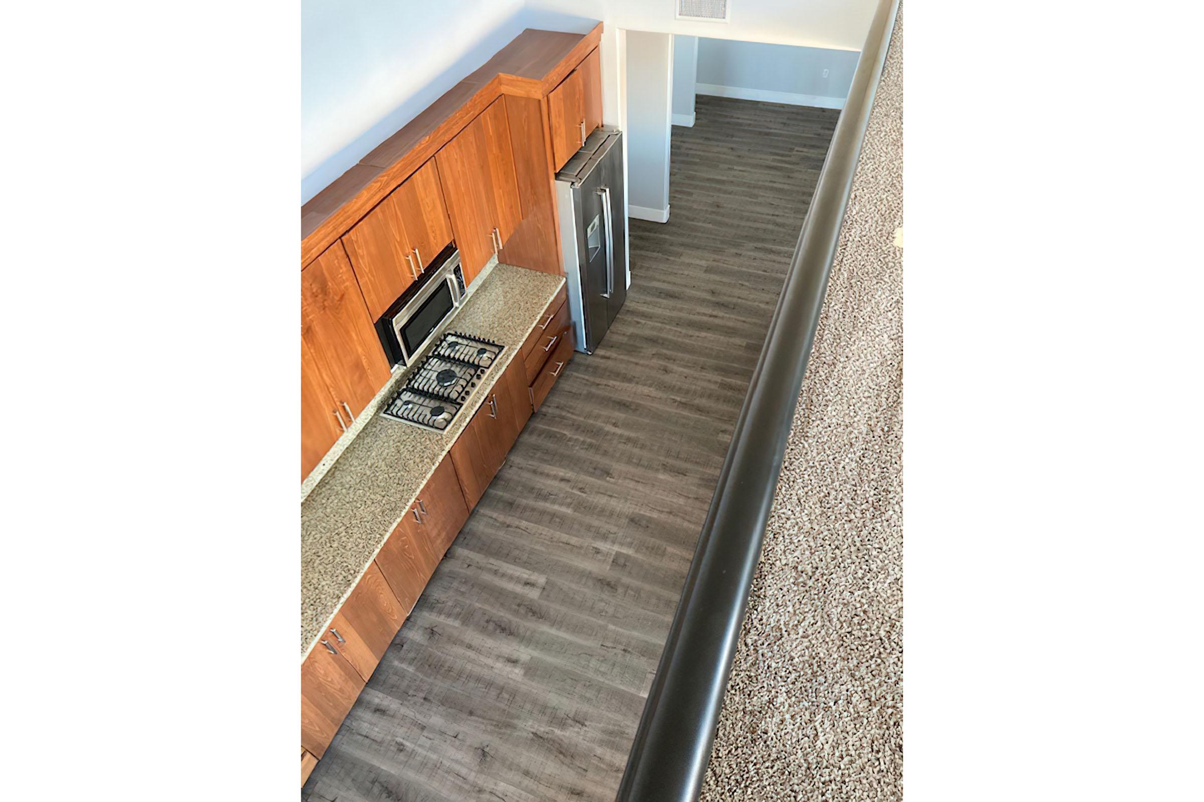 a kitchen with wooden cabinets