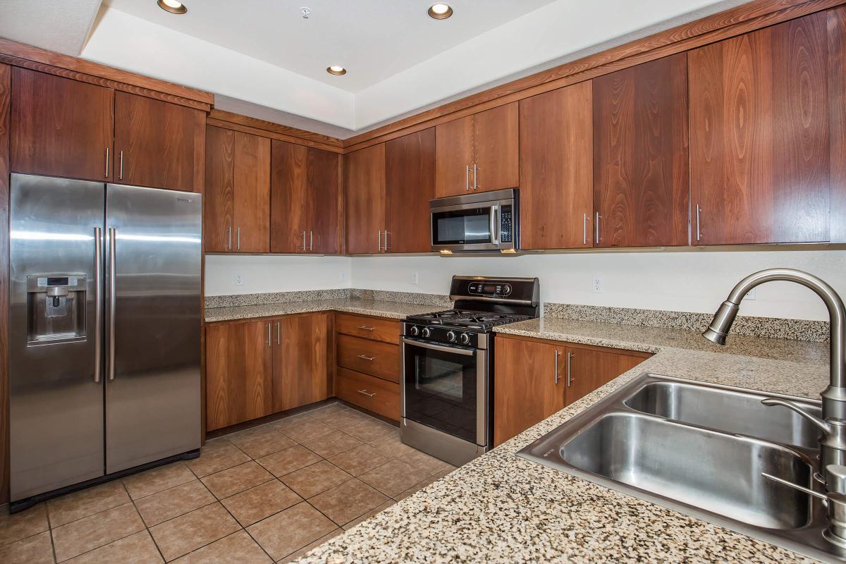 a kitchen with stainless steel appliances and wooden cabinets