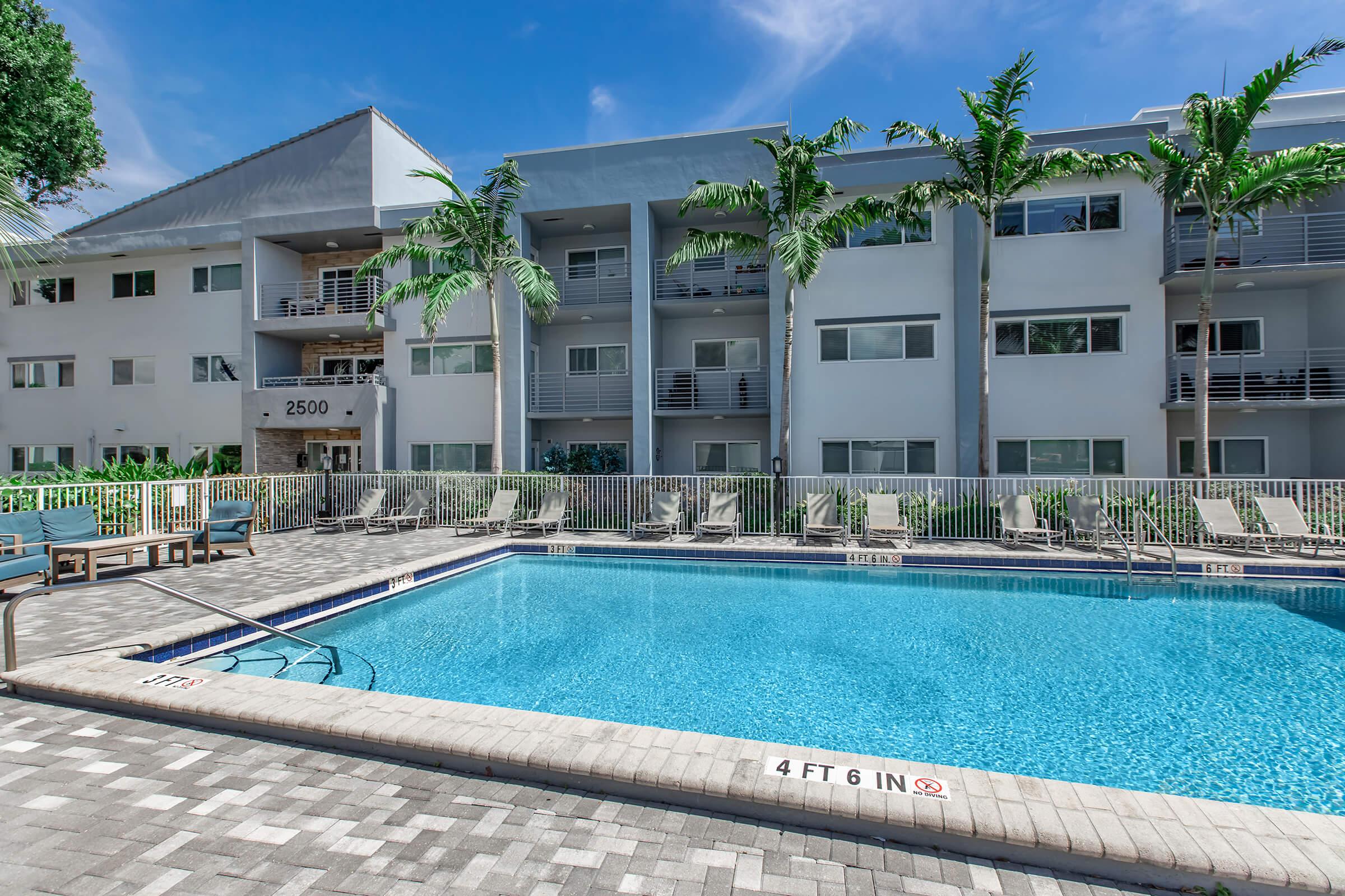 a large pool of water in front of a house