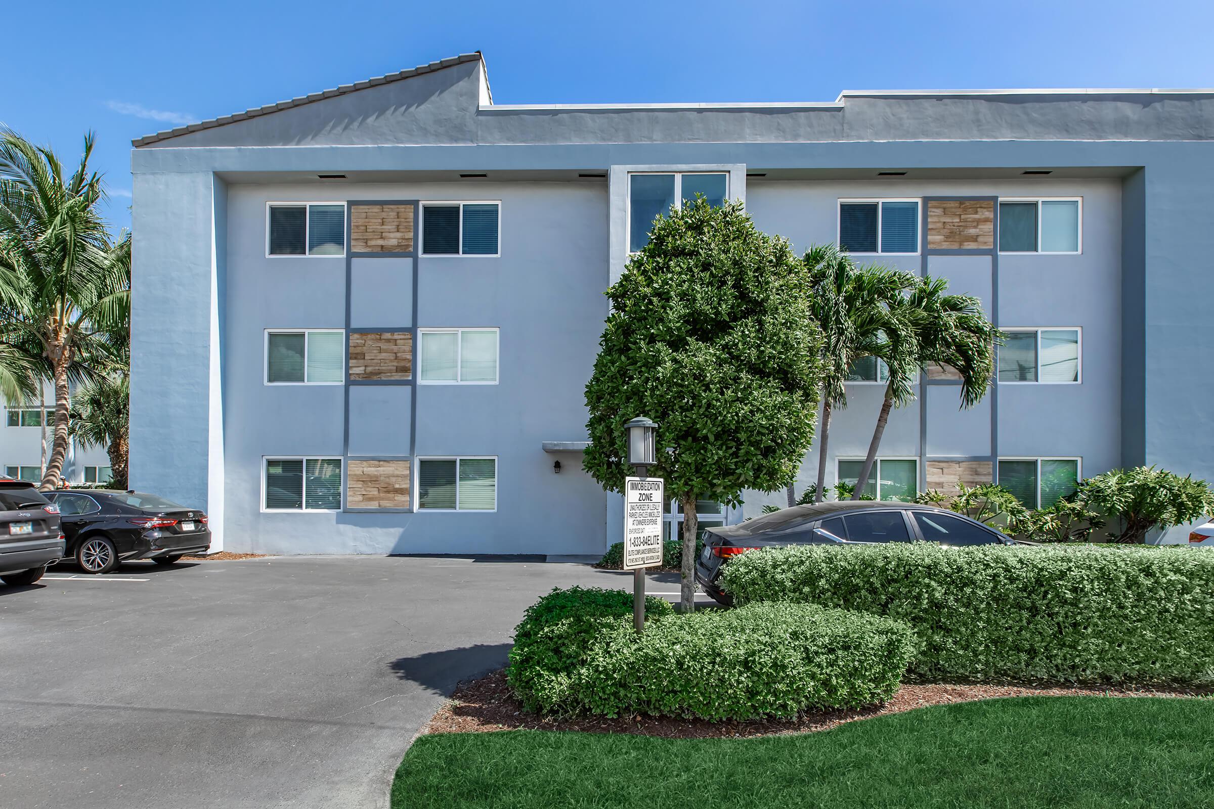 a house with bushes in front of a building