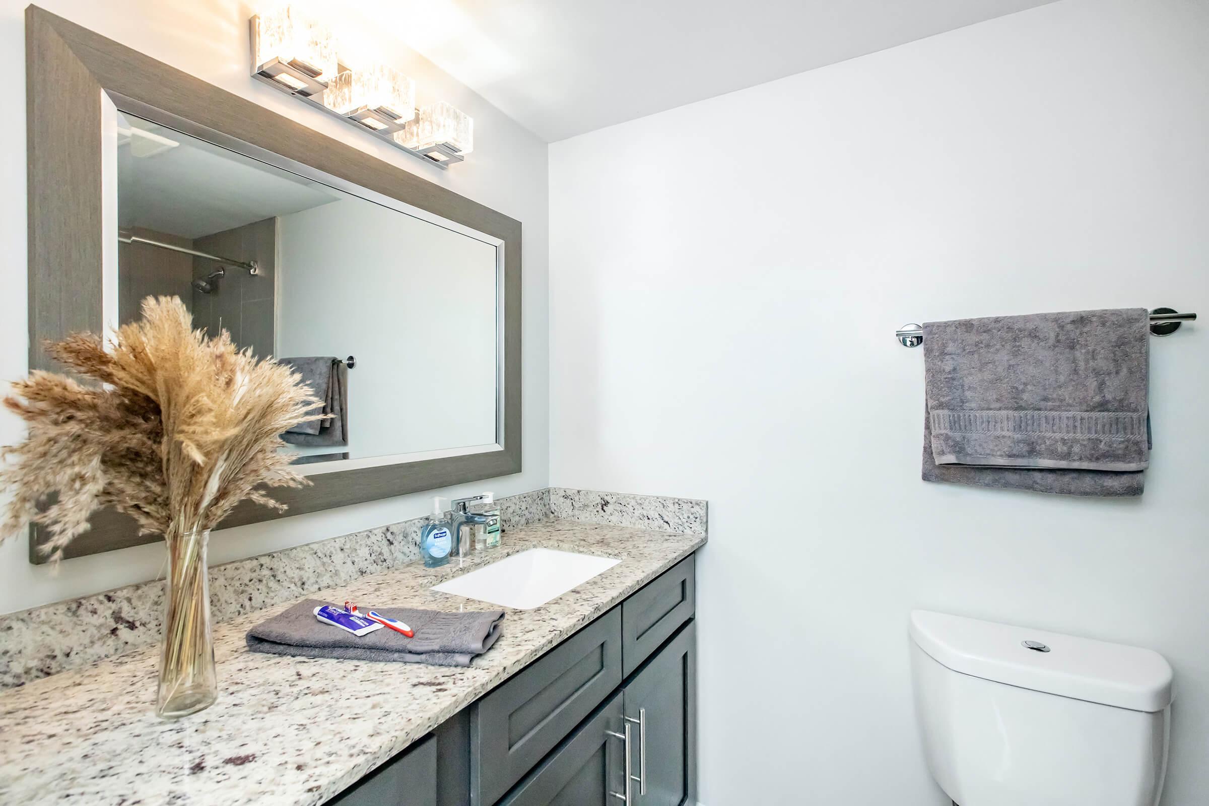 a kitchen with a sink and a mirror