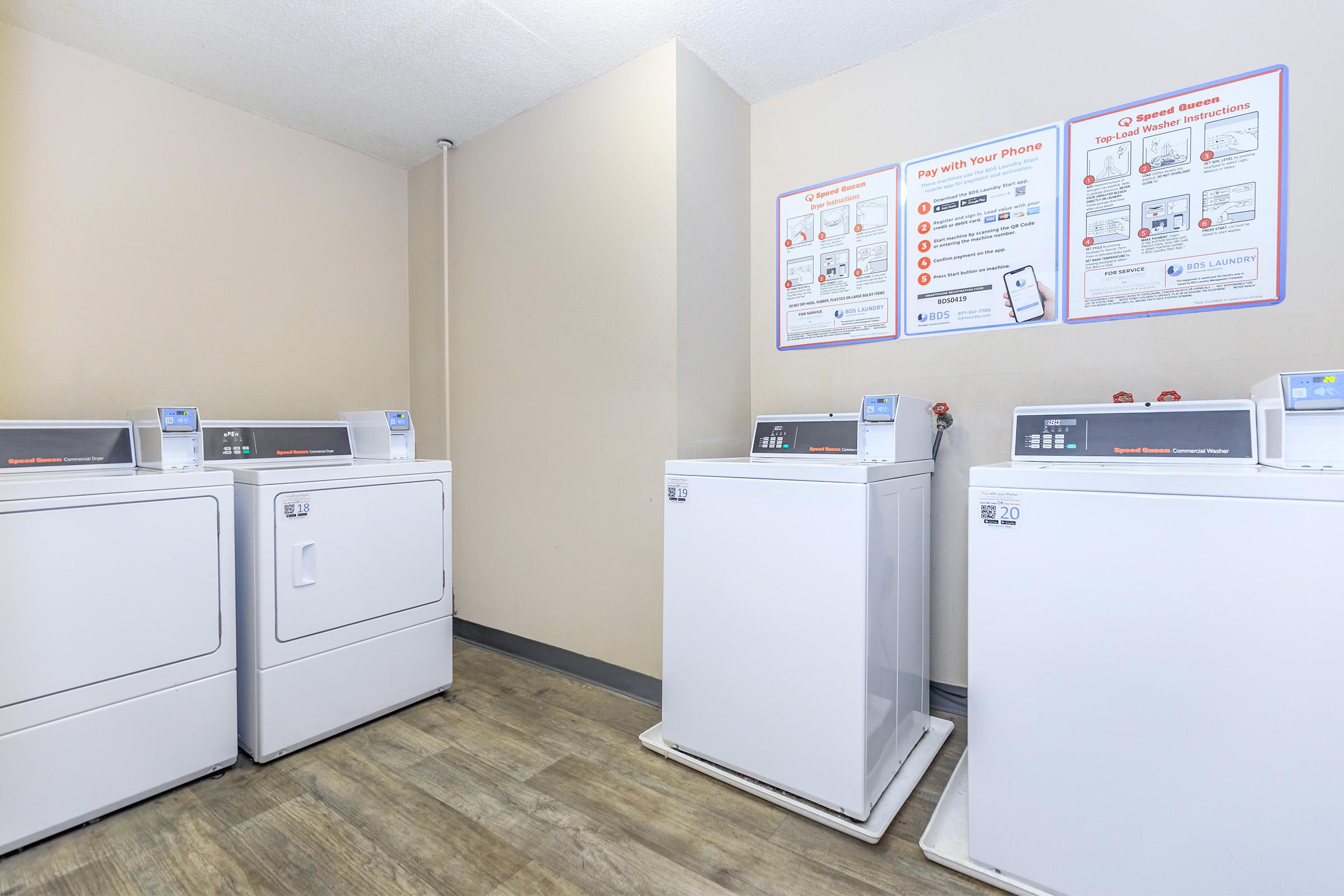 a kitchen with a white refrigerator freezer sitting in a room