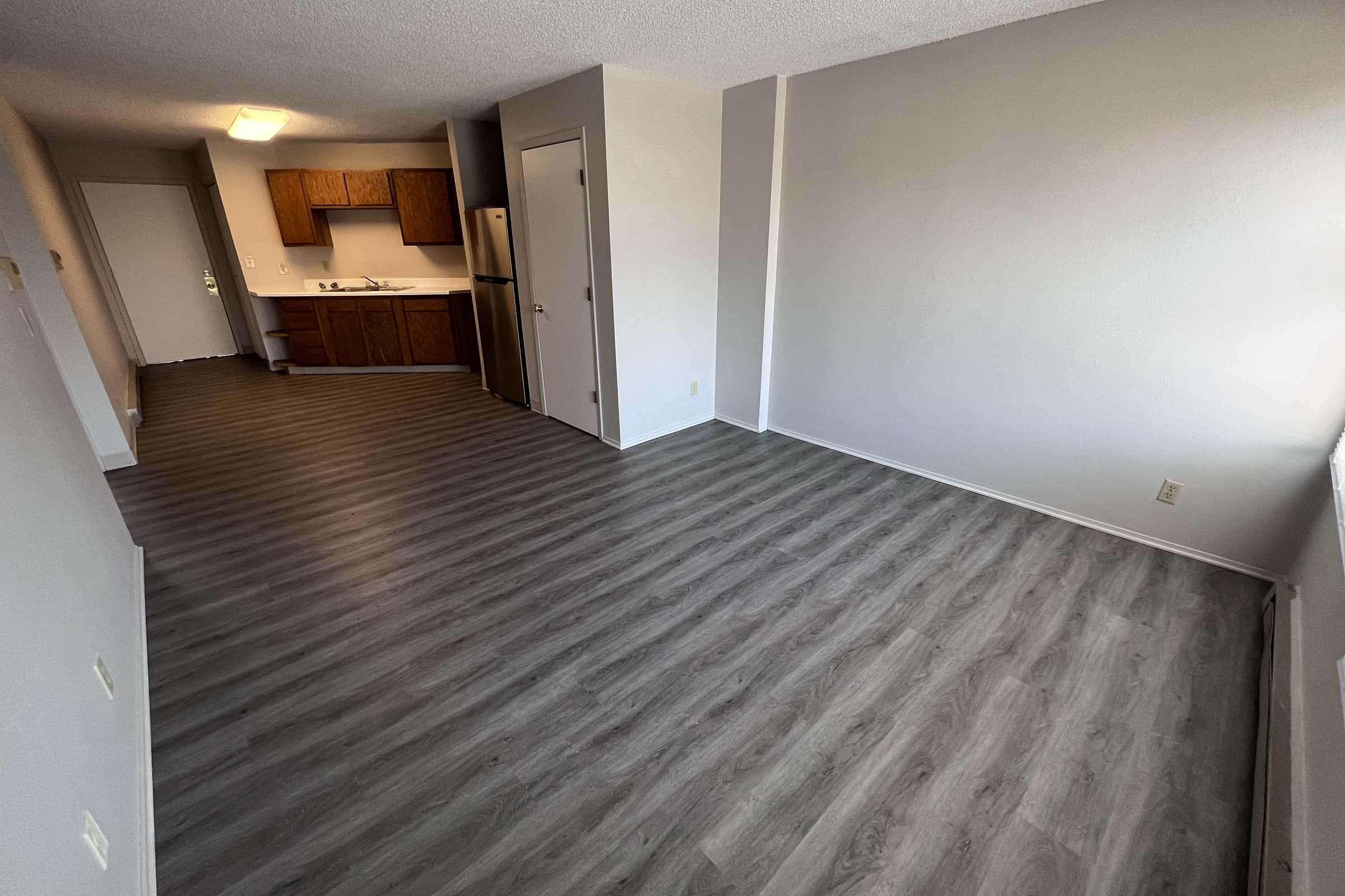 a bedroom with a wooden floor