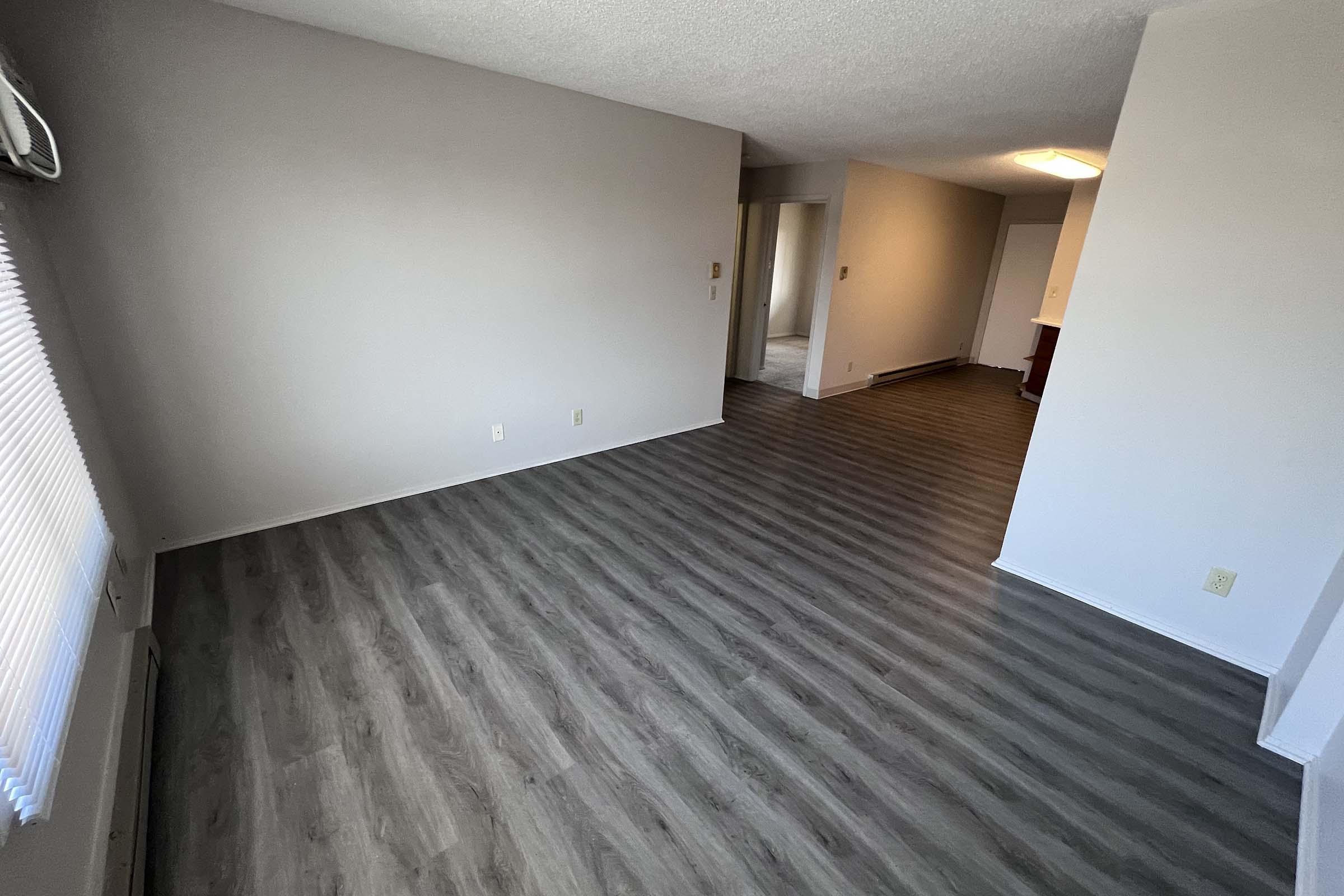 a bedroom with a wooden floor