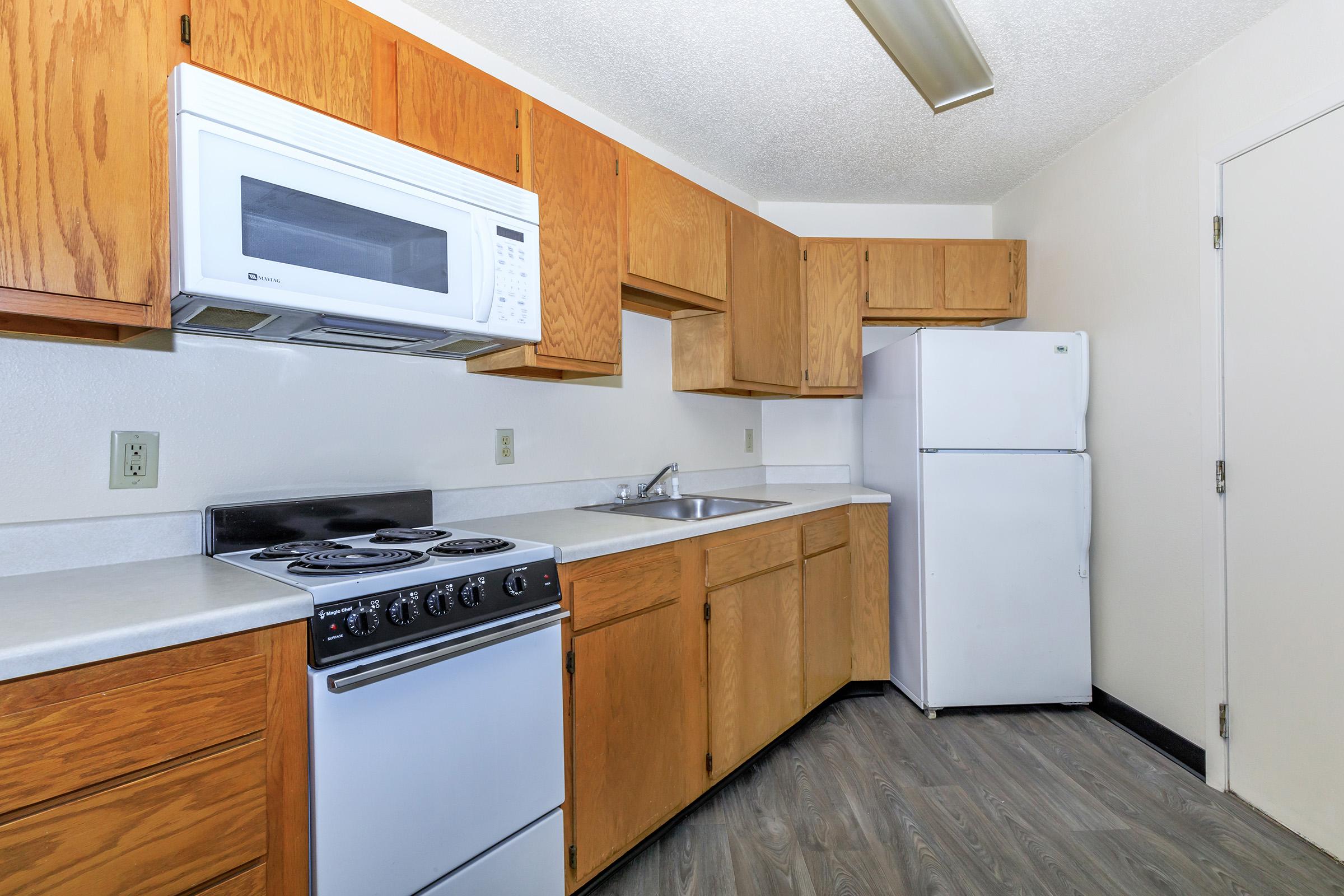 a kitchen with a stove and a refrigerator