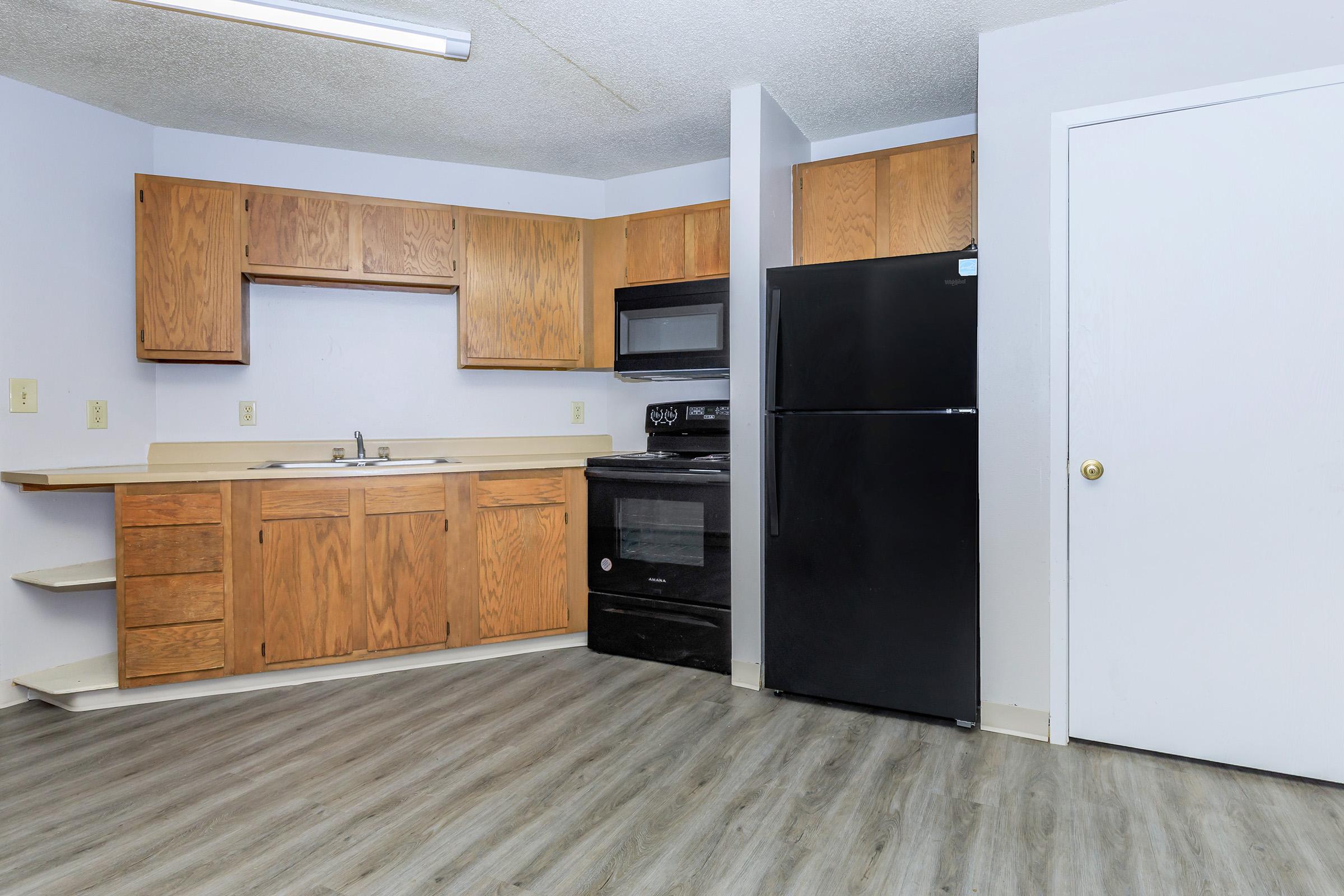 a kitchen with a stove and a refrigerator