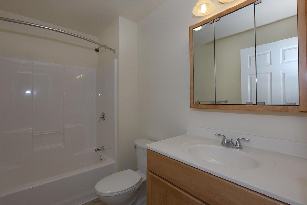 a large white tub next to a sink