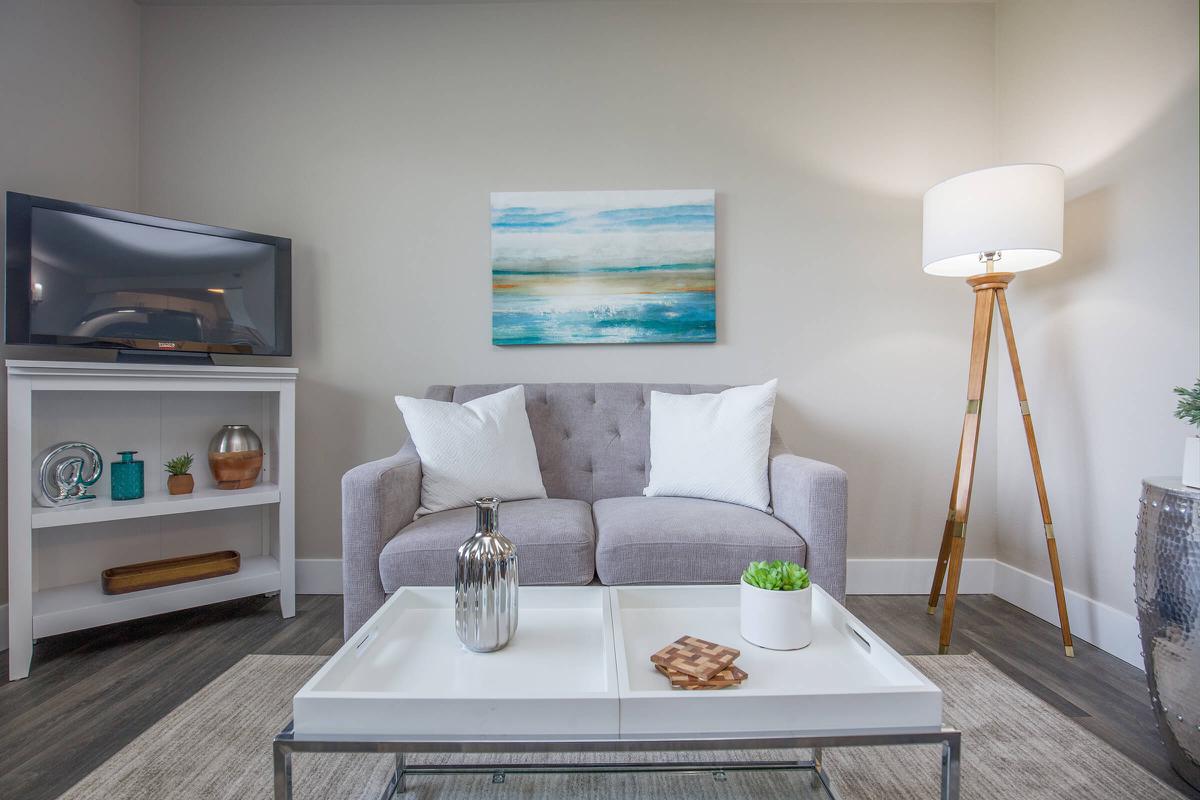 a living room filled with furniture and a flat screen tv