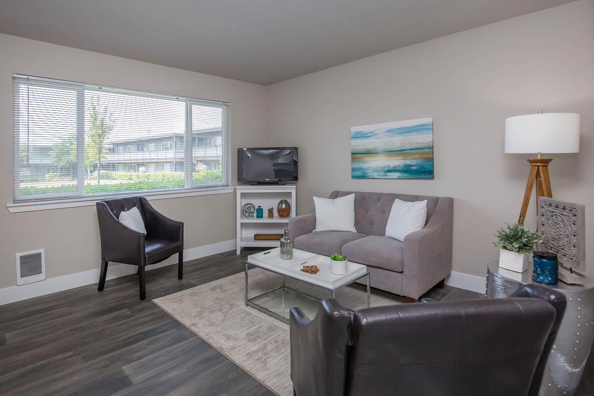 a living room filled with furniture and a flat screen tv