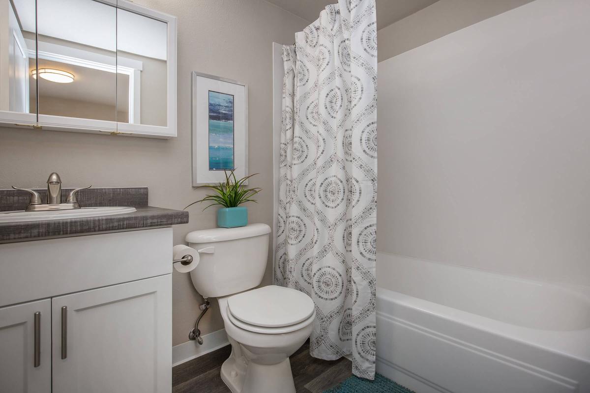 a white tub sitting next to a sink