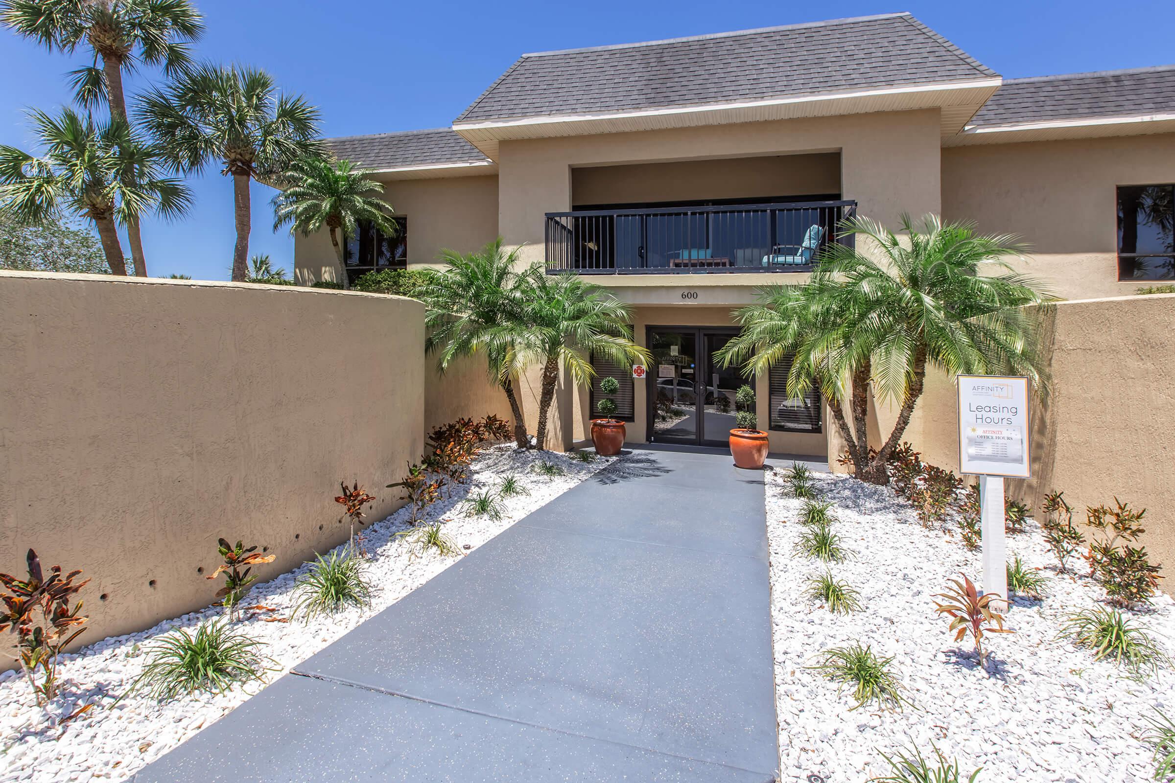 a palm tree in front of a house