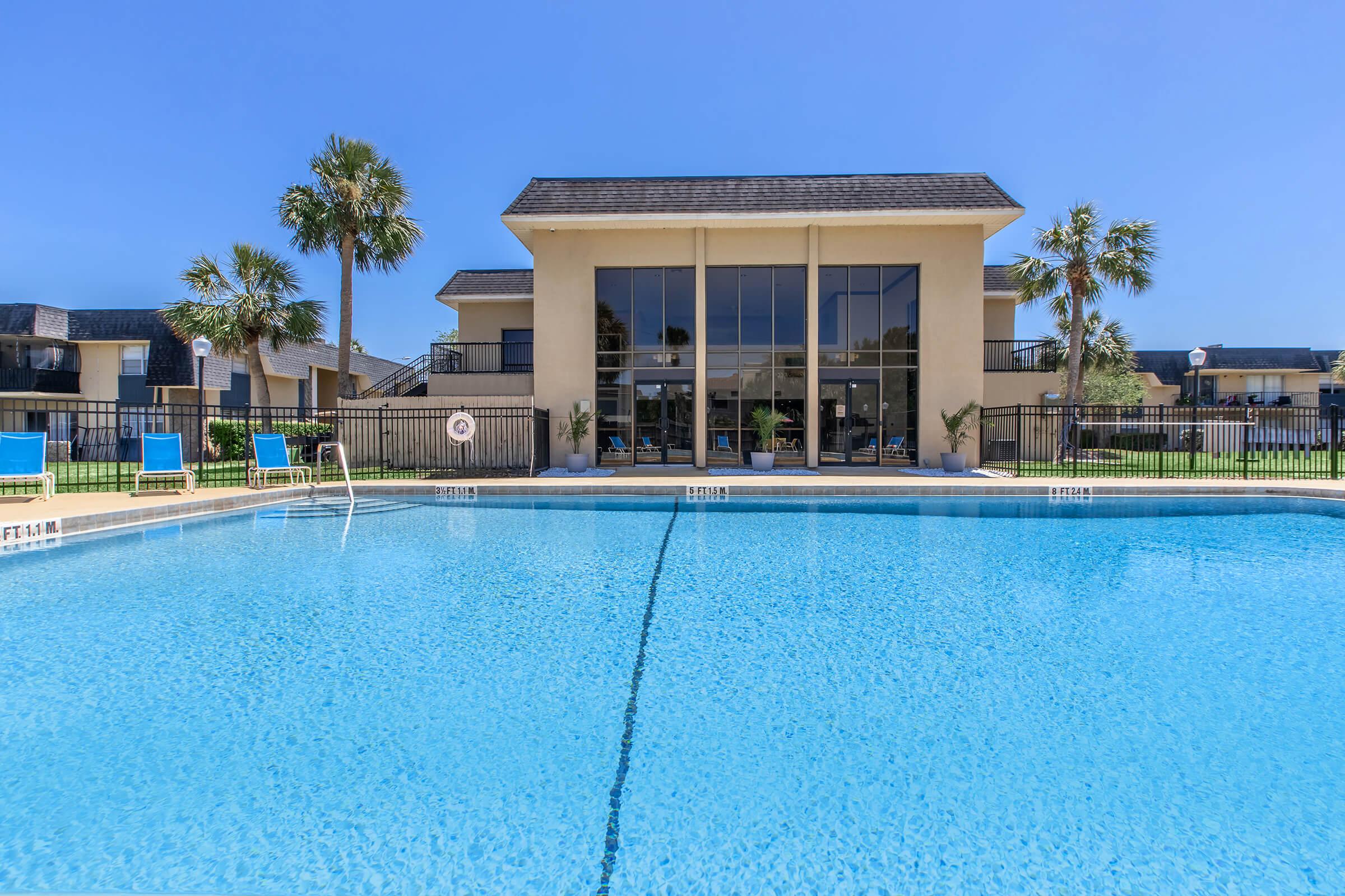 a blue pool of water in front of a building