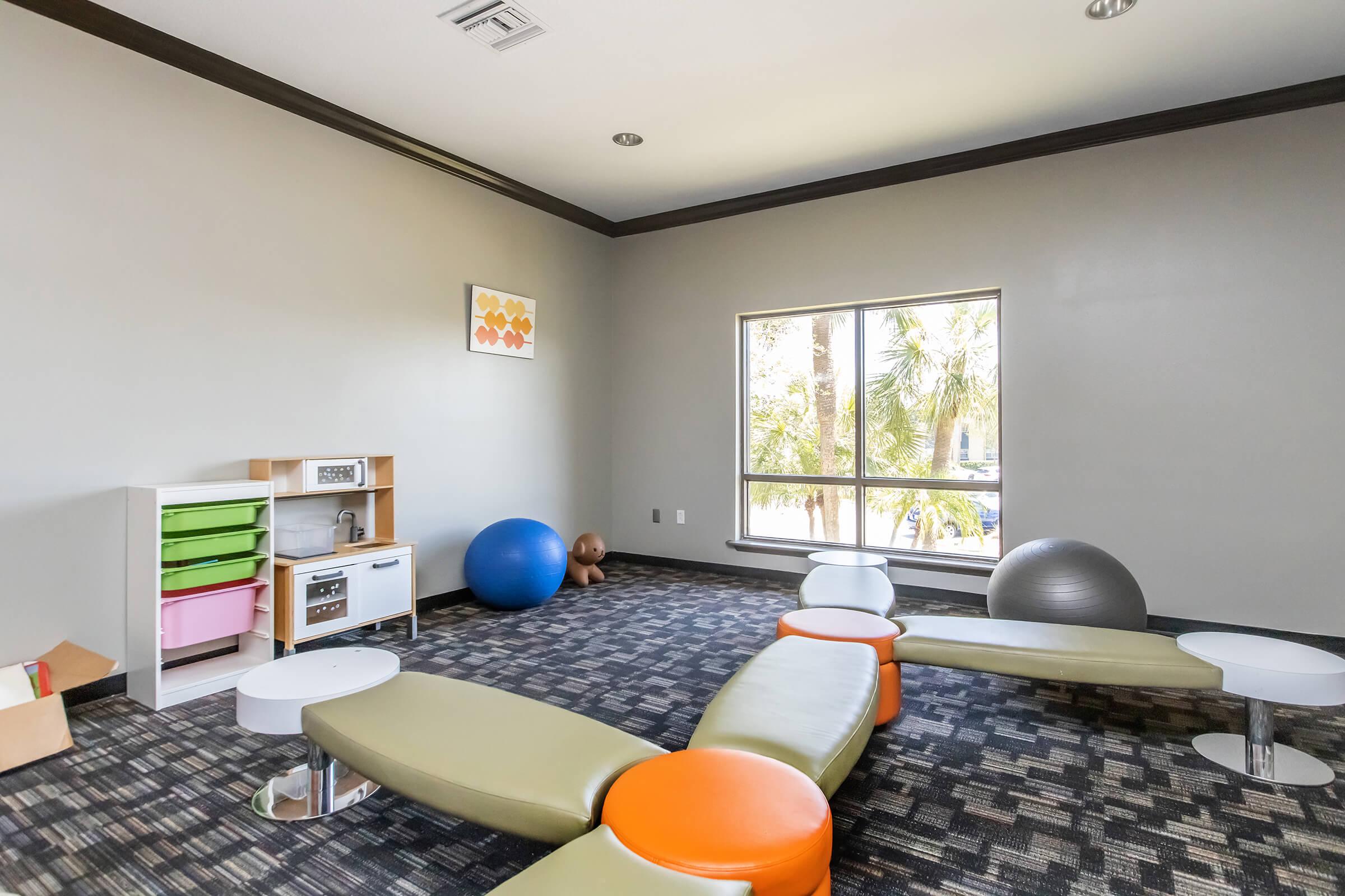 a living area with a desk and chair in a room