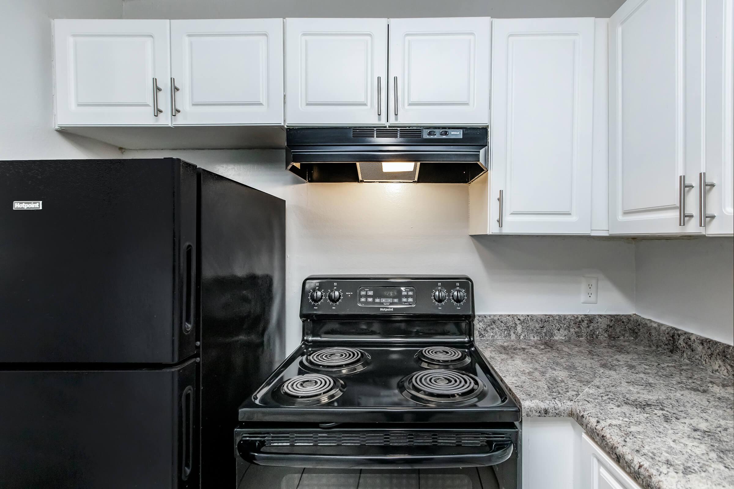 a stove top oven sitting inside of a kitchen