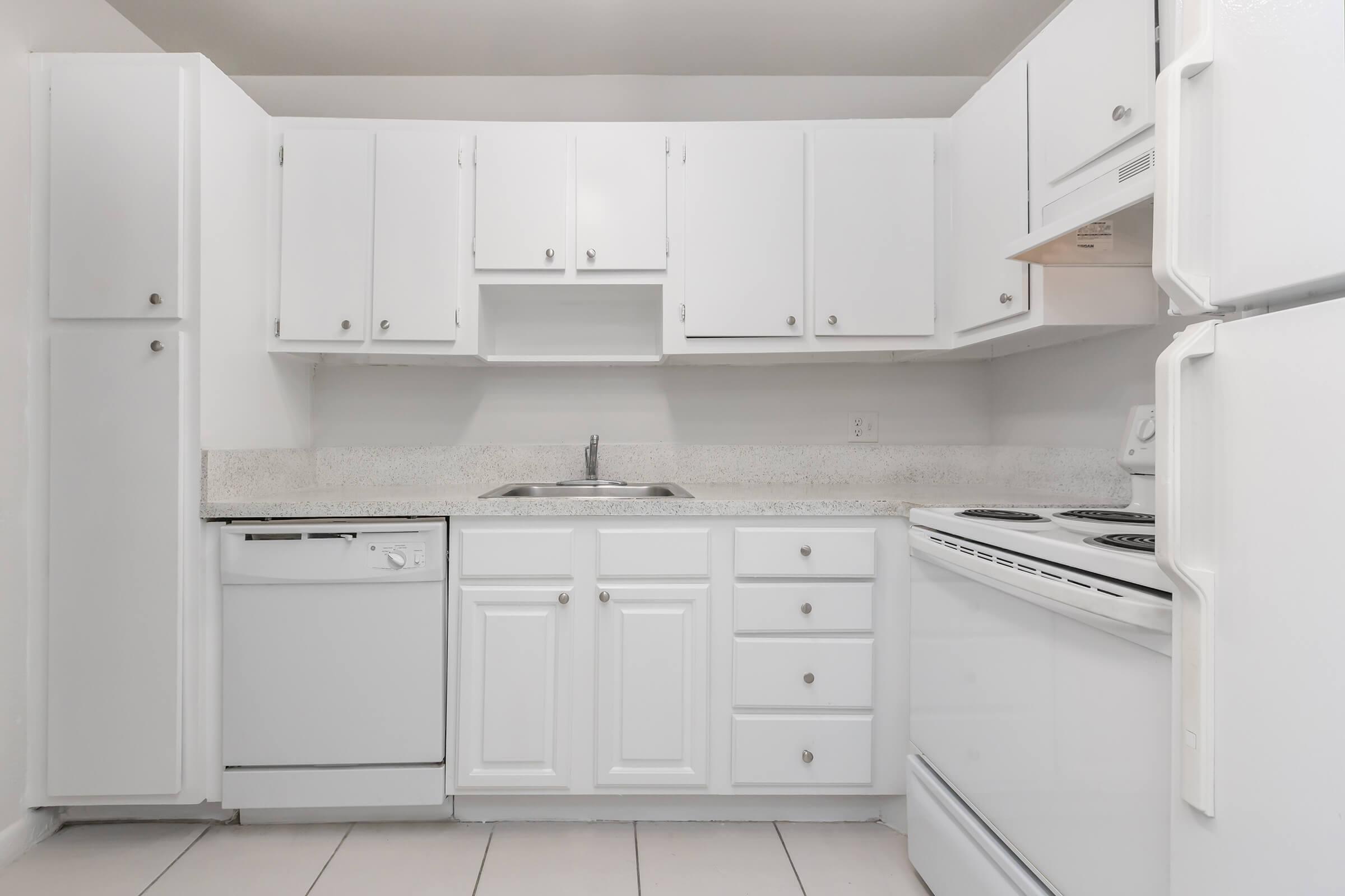 a kitchen with a stove and a refrigerator