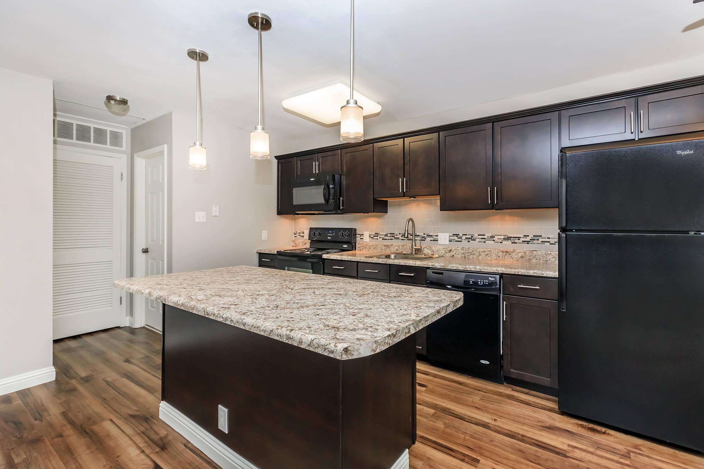 a modern kitchen with stainless steel appliances and wooden cabinets