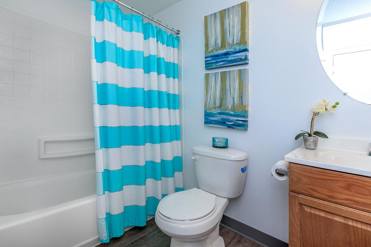 a white tub sitting next to a shower