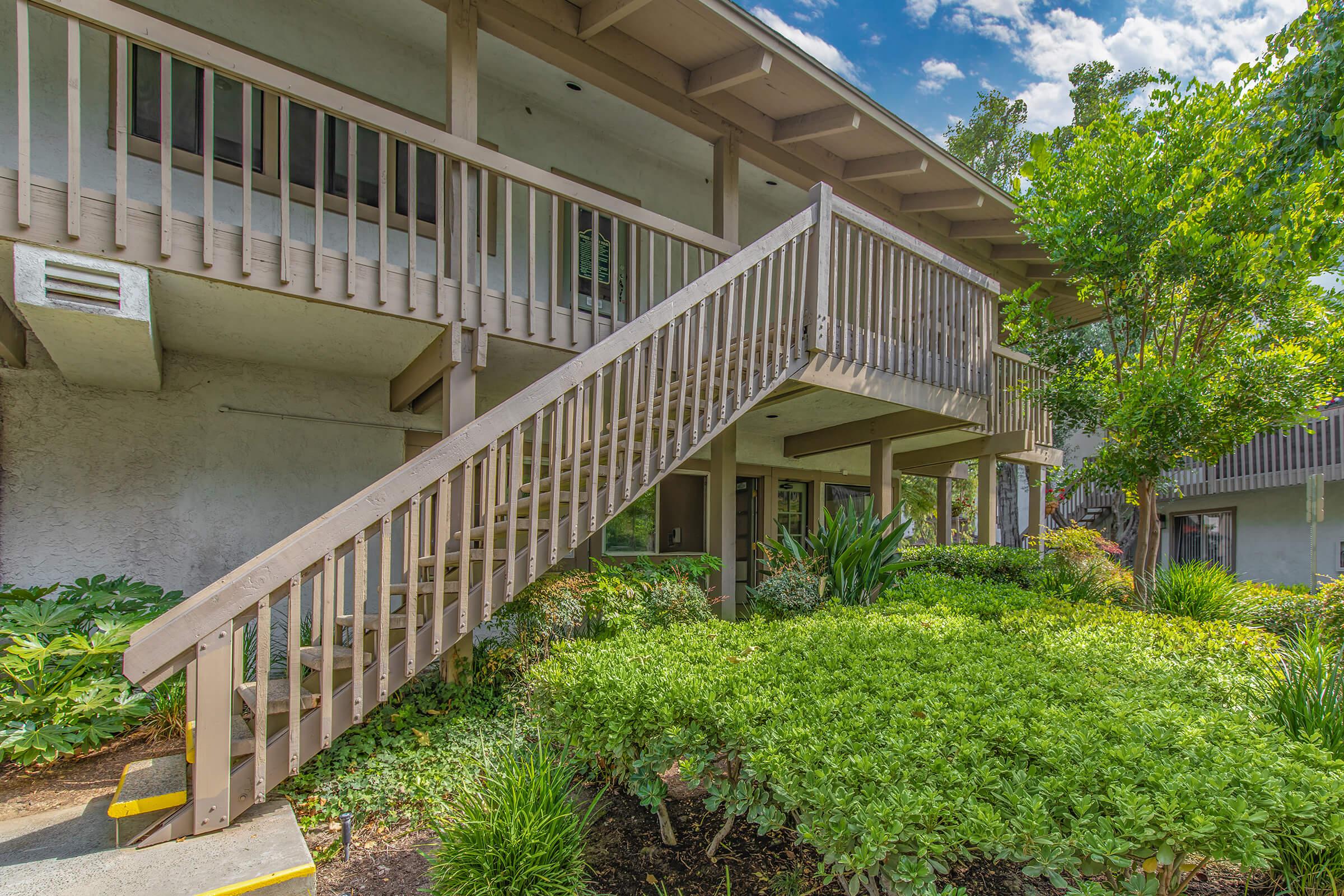 stairs in front of a community building with green plants