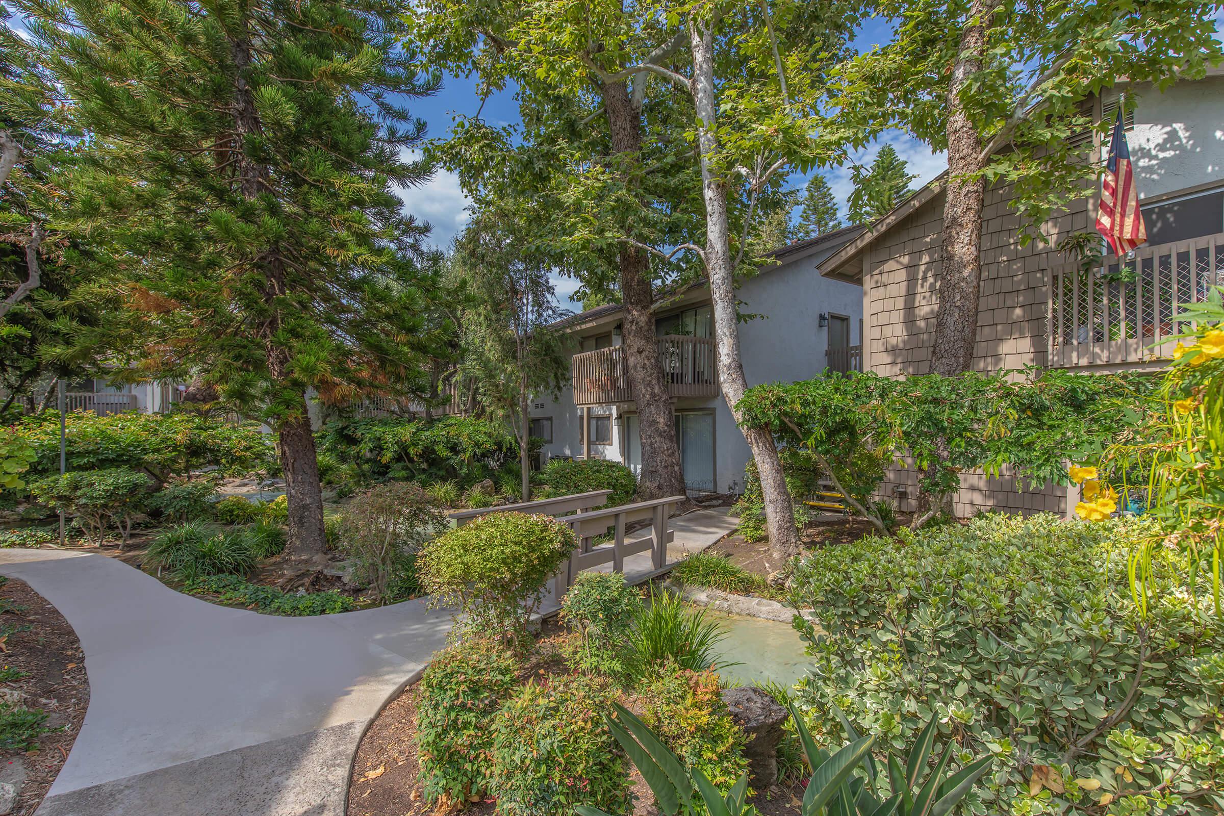 Moss Creek Apartments walkway with green plants