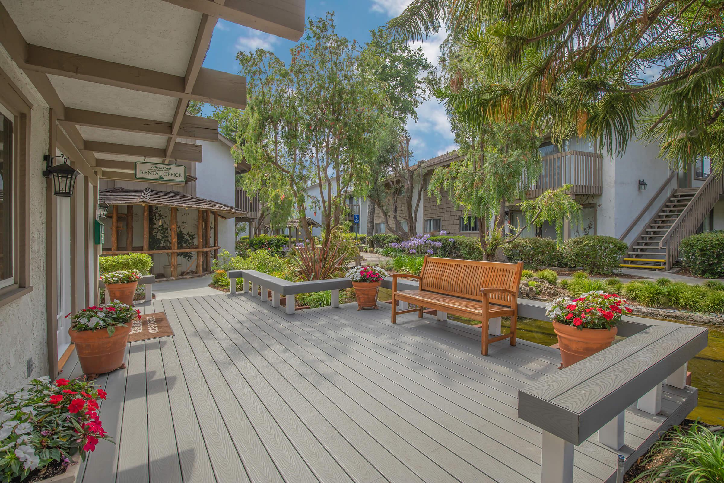 the community patio with a wooden bench