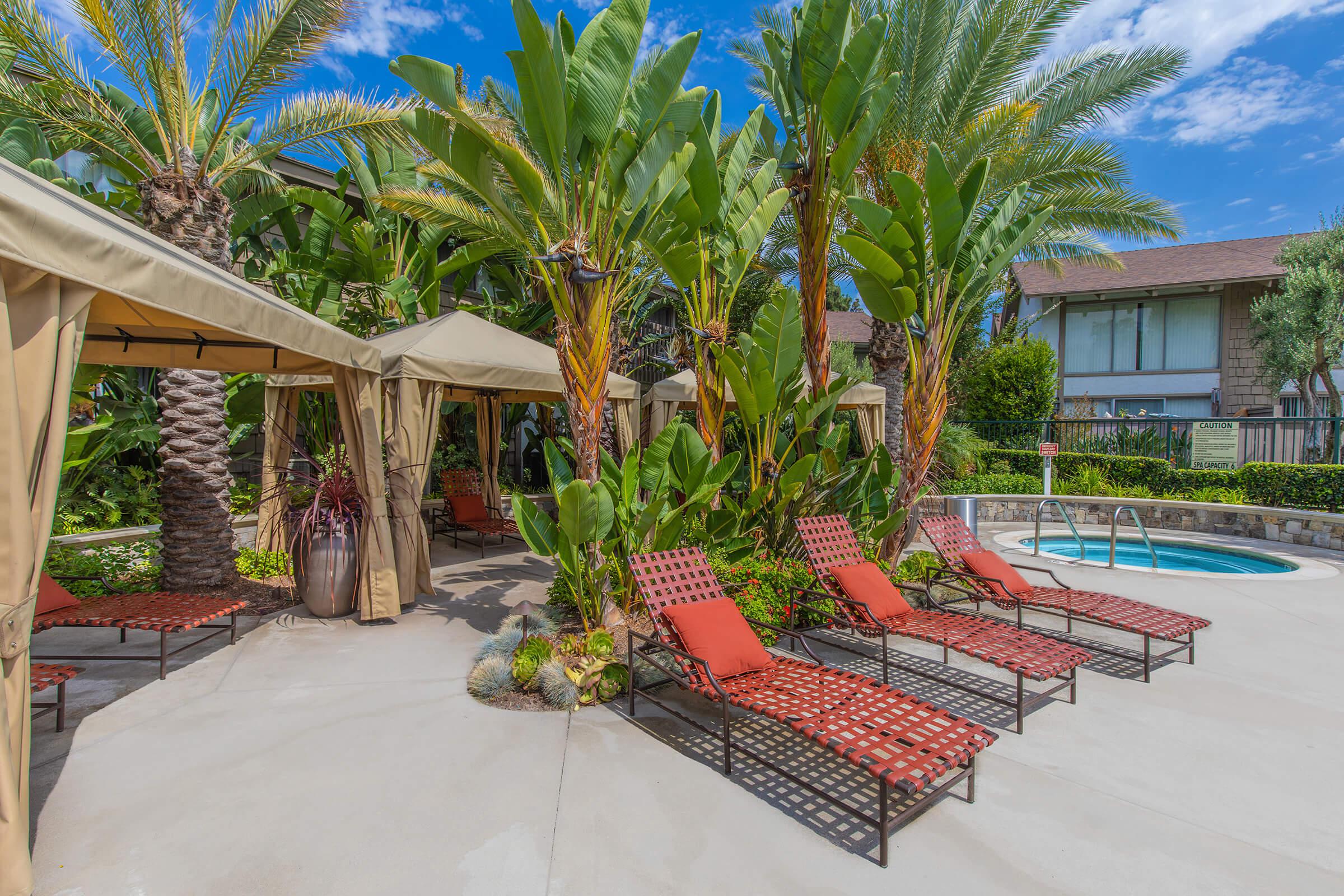 red lounge chairs next to the community pool