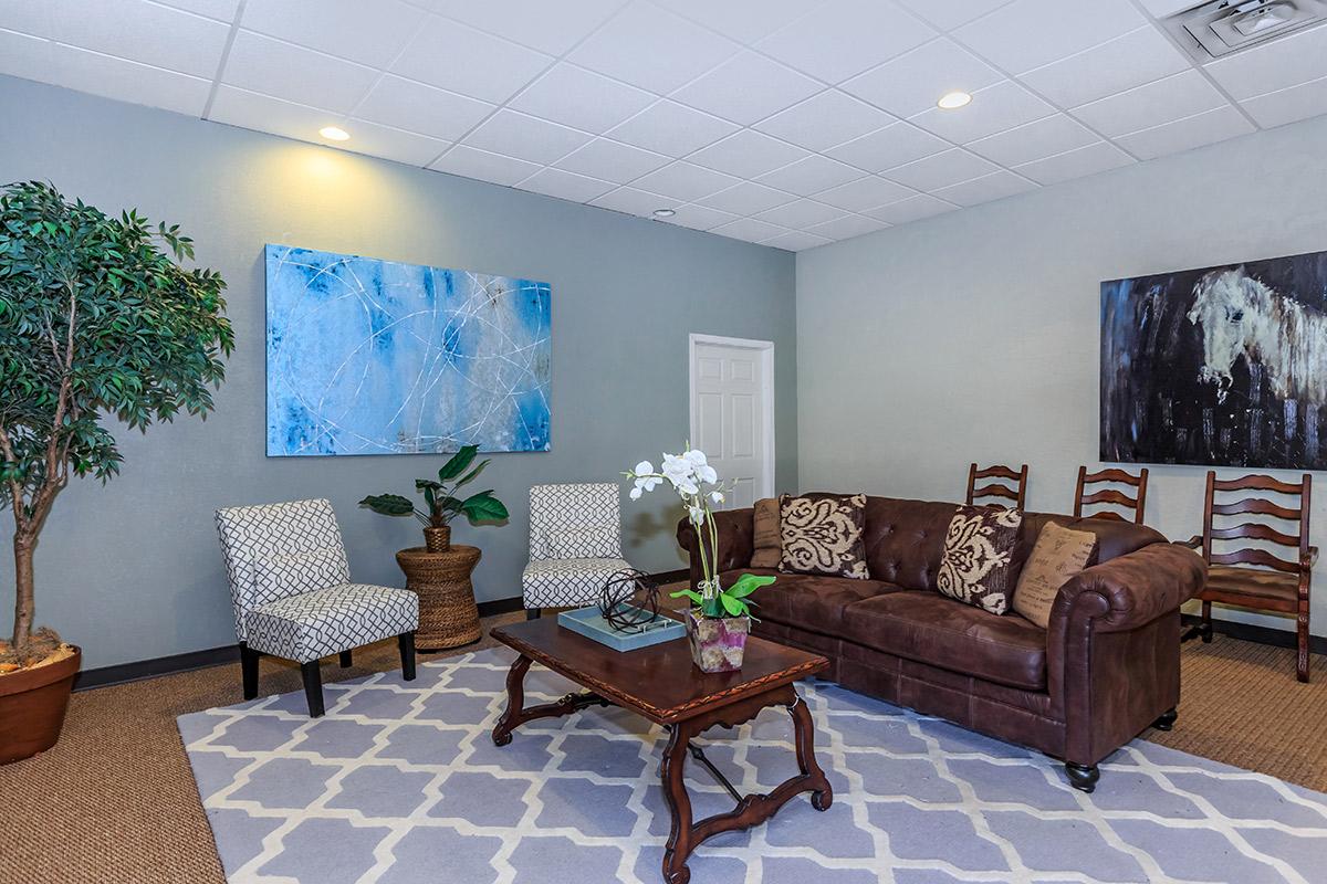 a living room filled with furniture and a flat screen tv