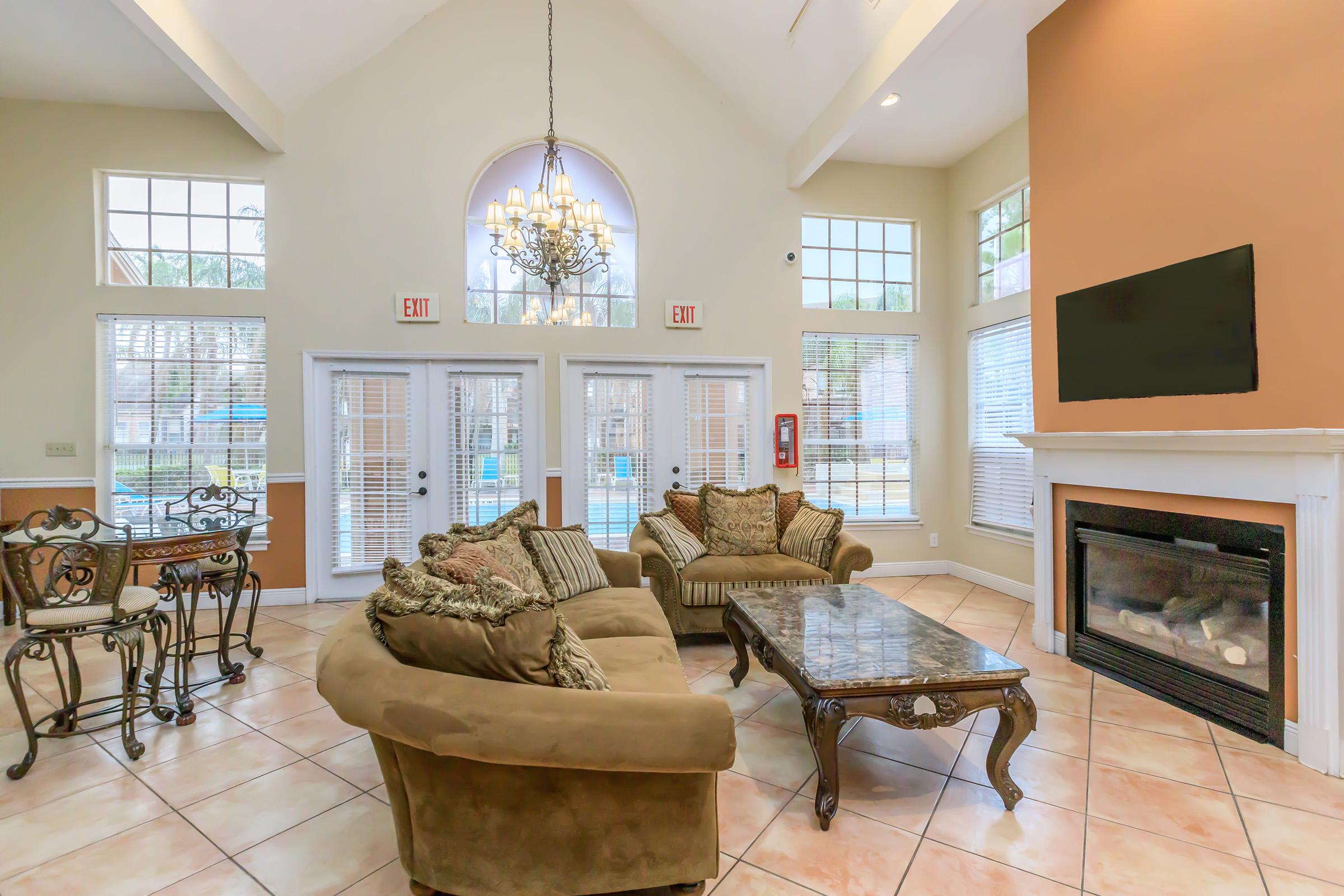 a living room filled with furniture and a fireplace