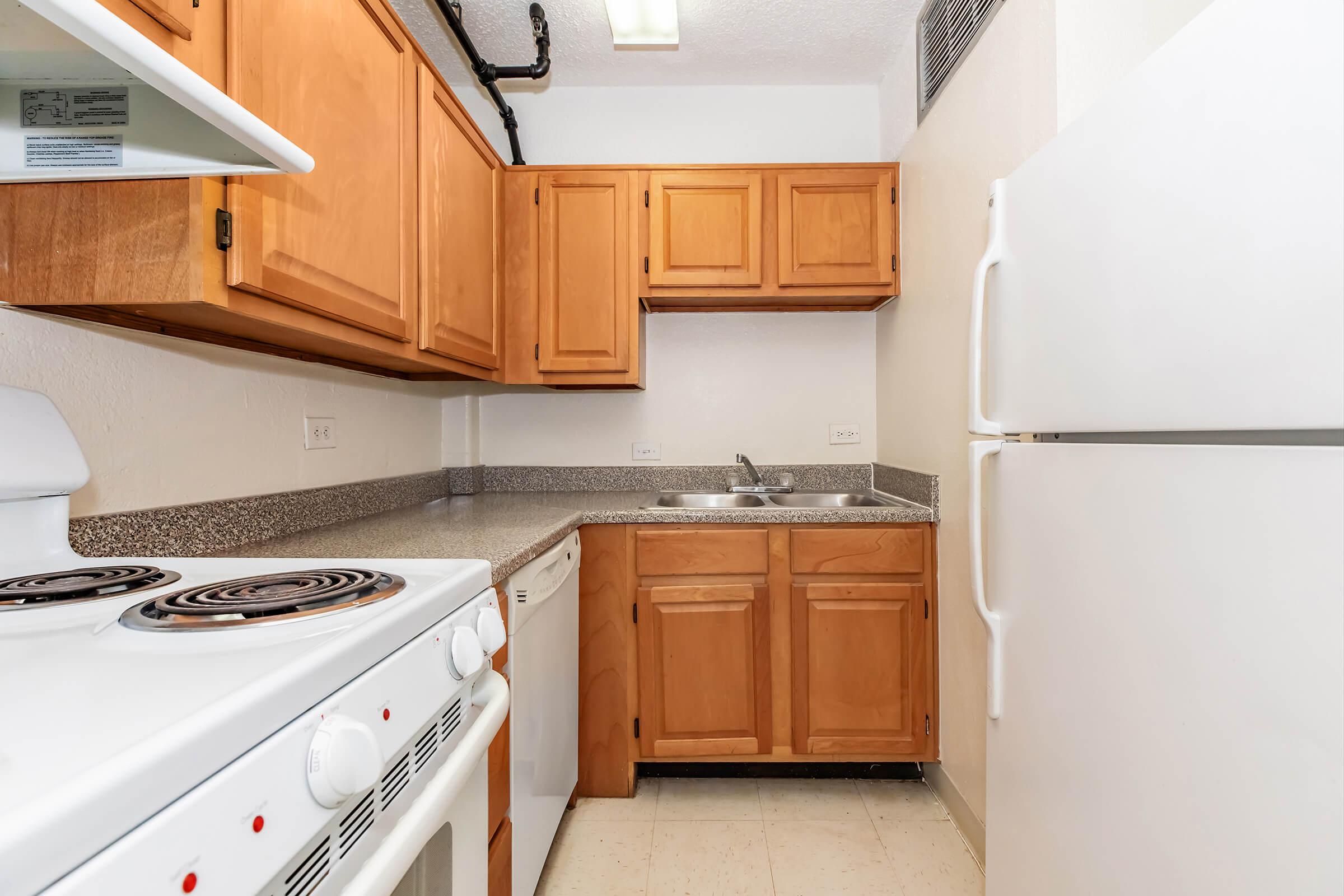 a kitchen with a stove and a refrigerator