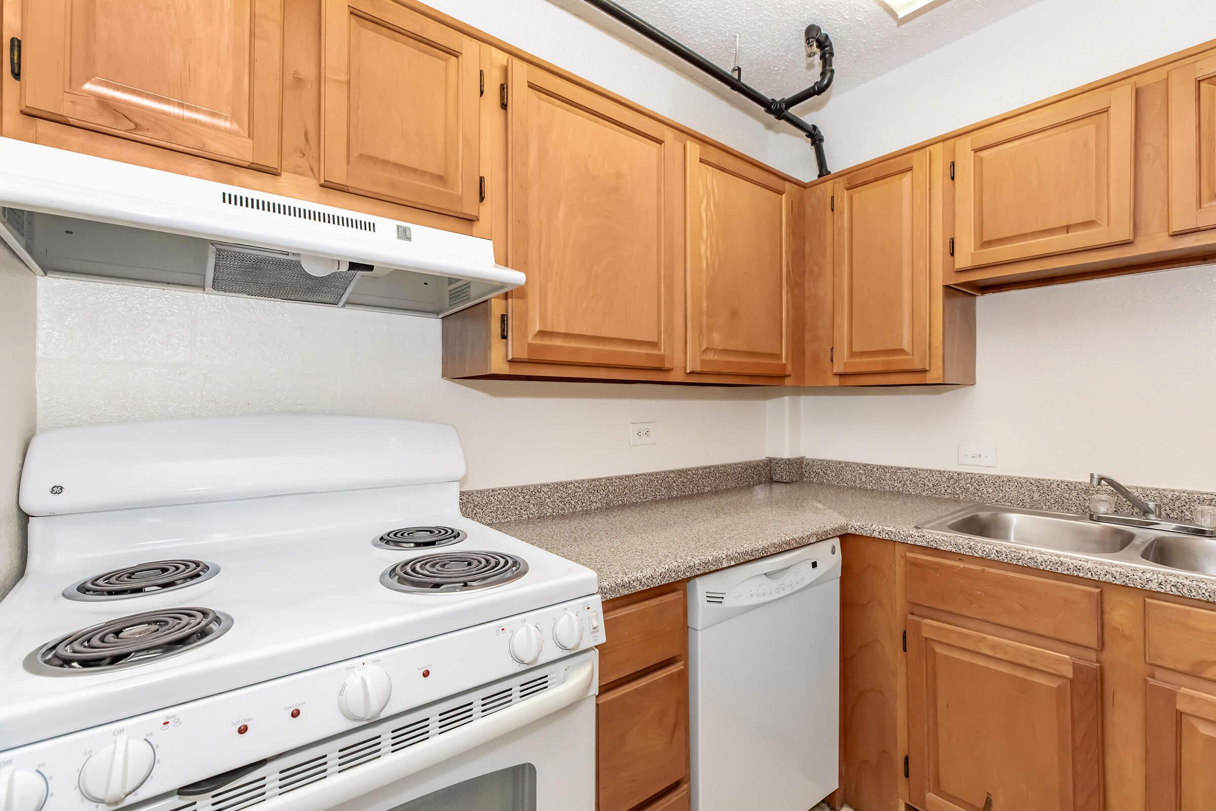 a stove top oven sitting inside of a kitchen