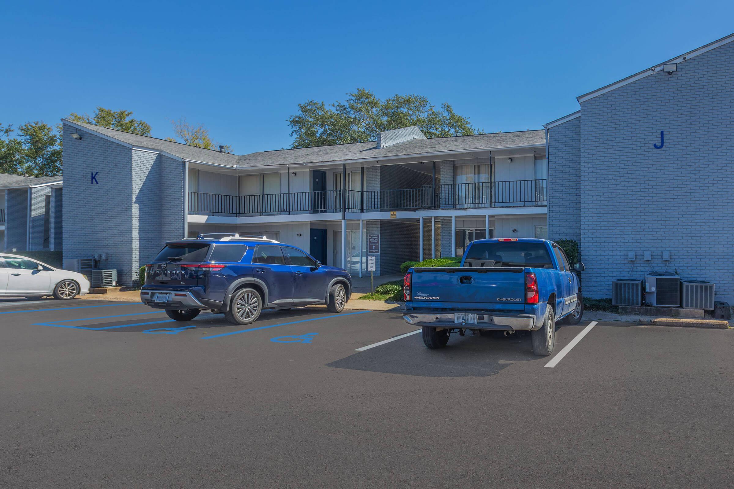 a car parked in a parking lot in front of a building