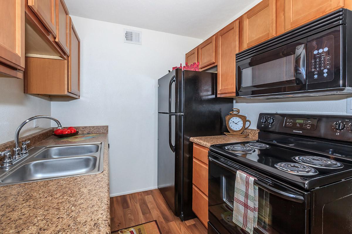 a kitchen with stainless steel appliances and wooden cabinets