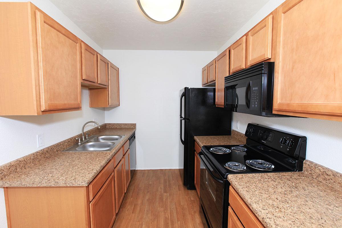 a kitchen with stainless steel appliances and wooden cabinets