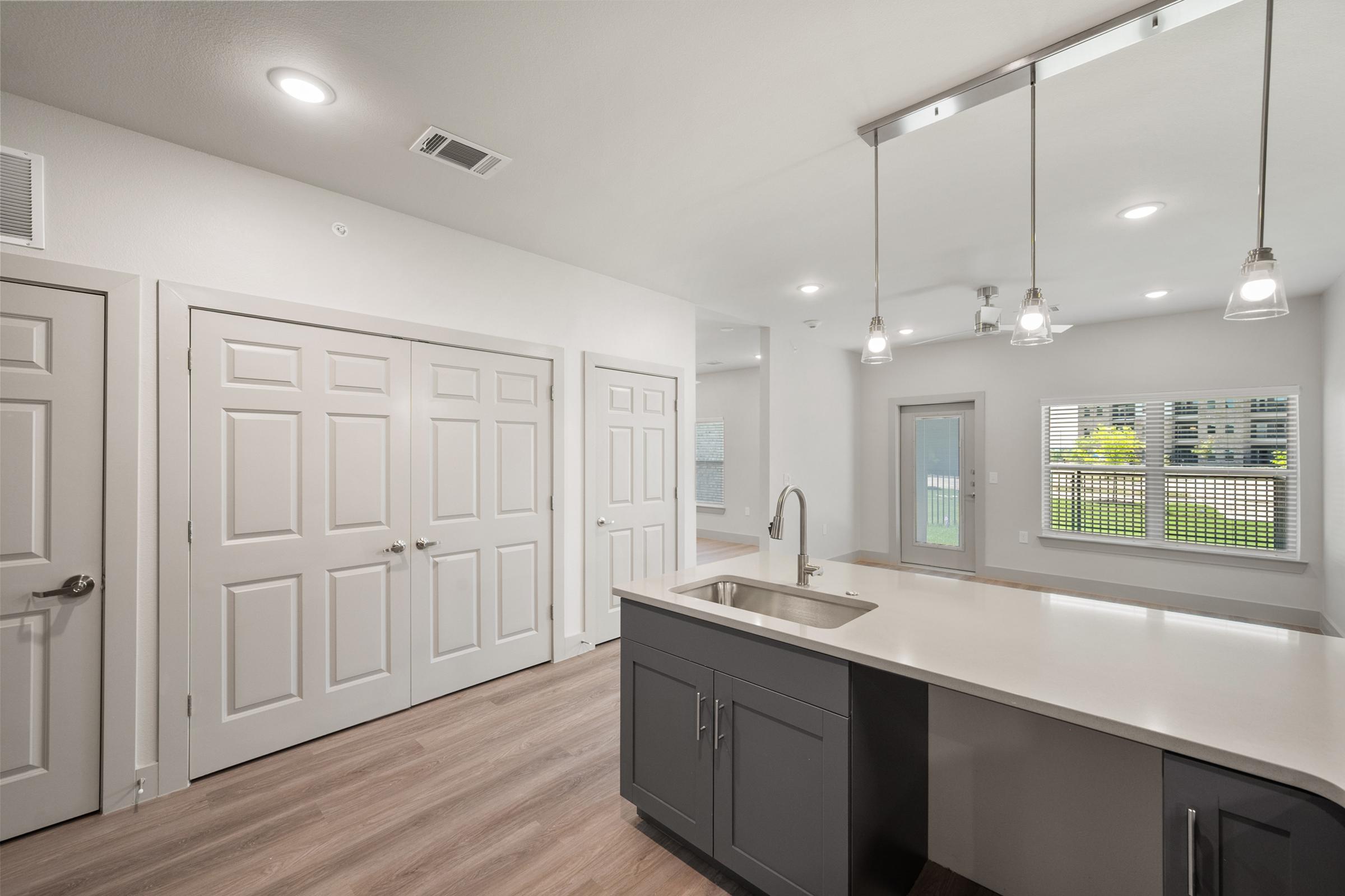 Modern kitchen in the A1 Floor Plan featuring stainless steel appliances, quartz countertops, and sleek cabinetry.